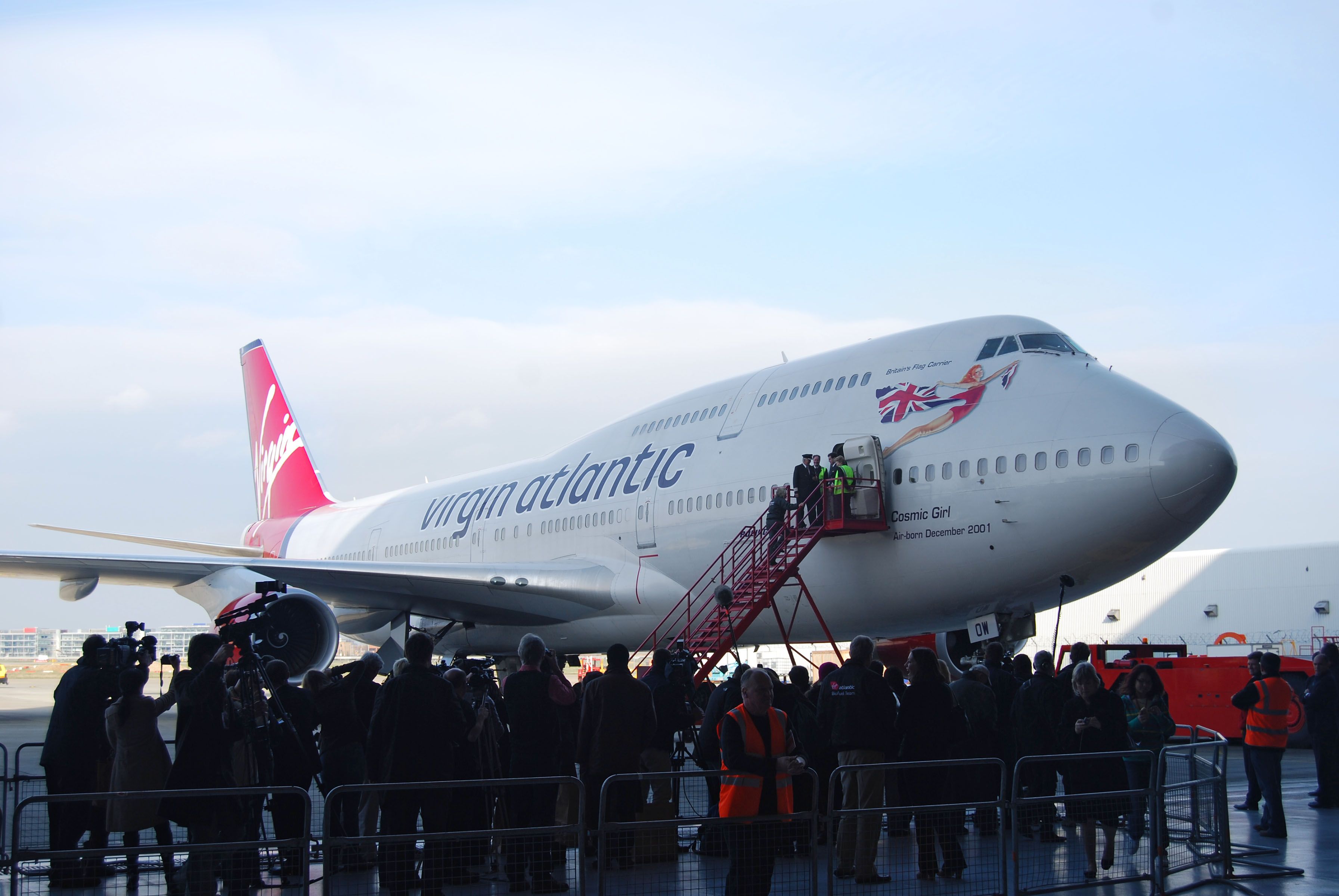 A Virgin Atlantic Boeing 747 Parked outside of a hangar.