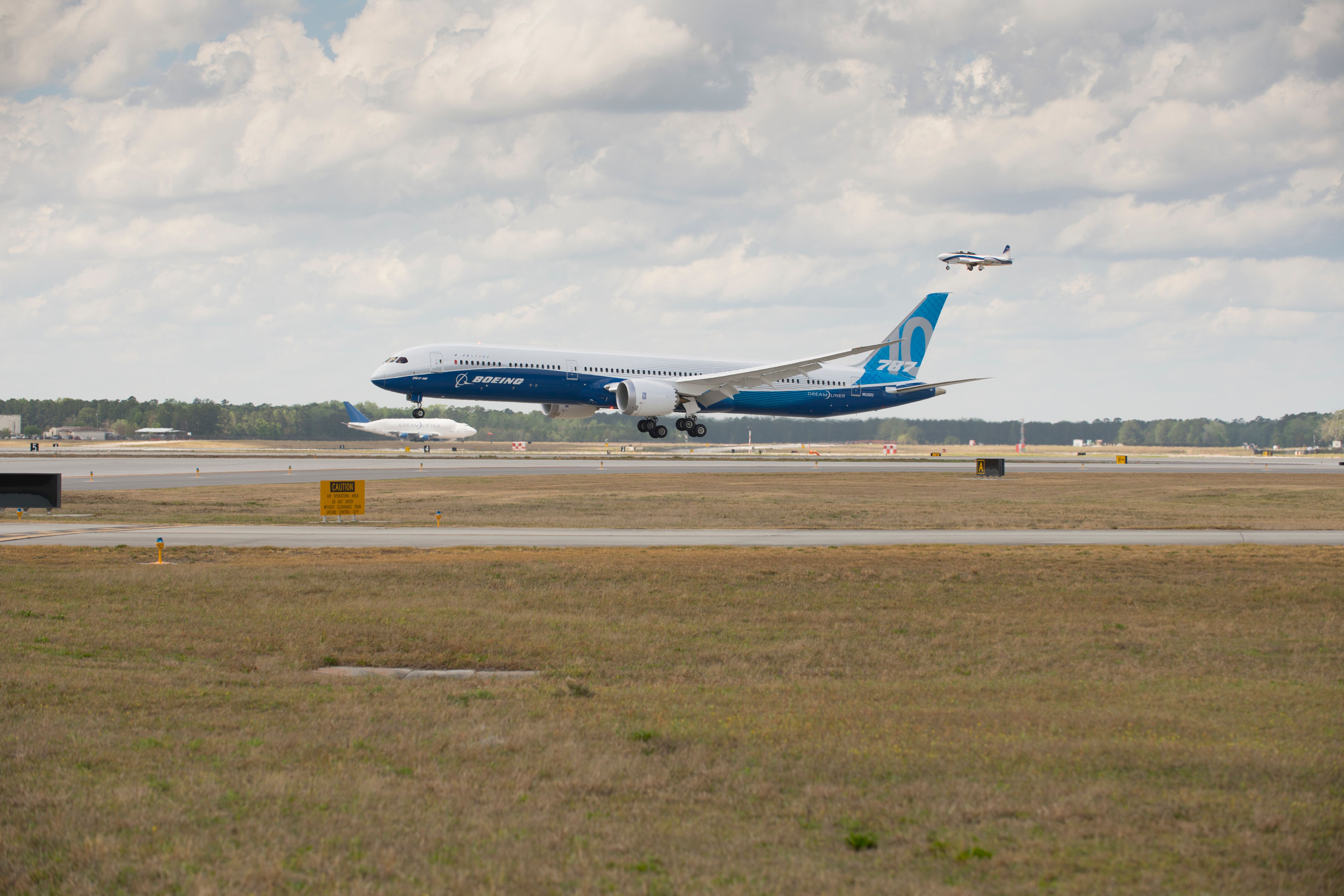 A Boeing 787-10 about to land on a runway.
