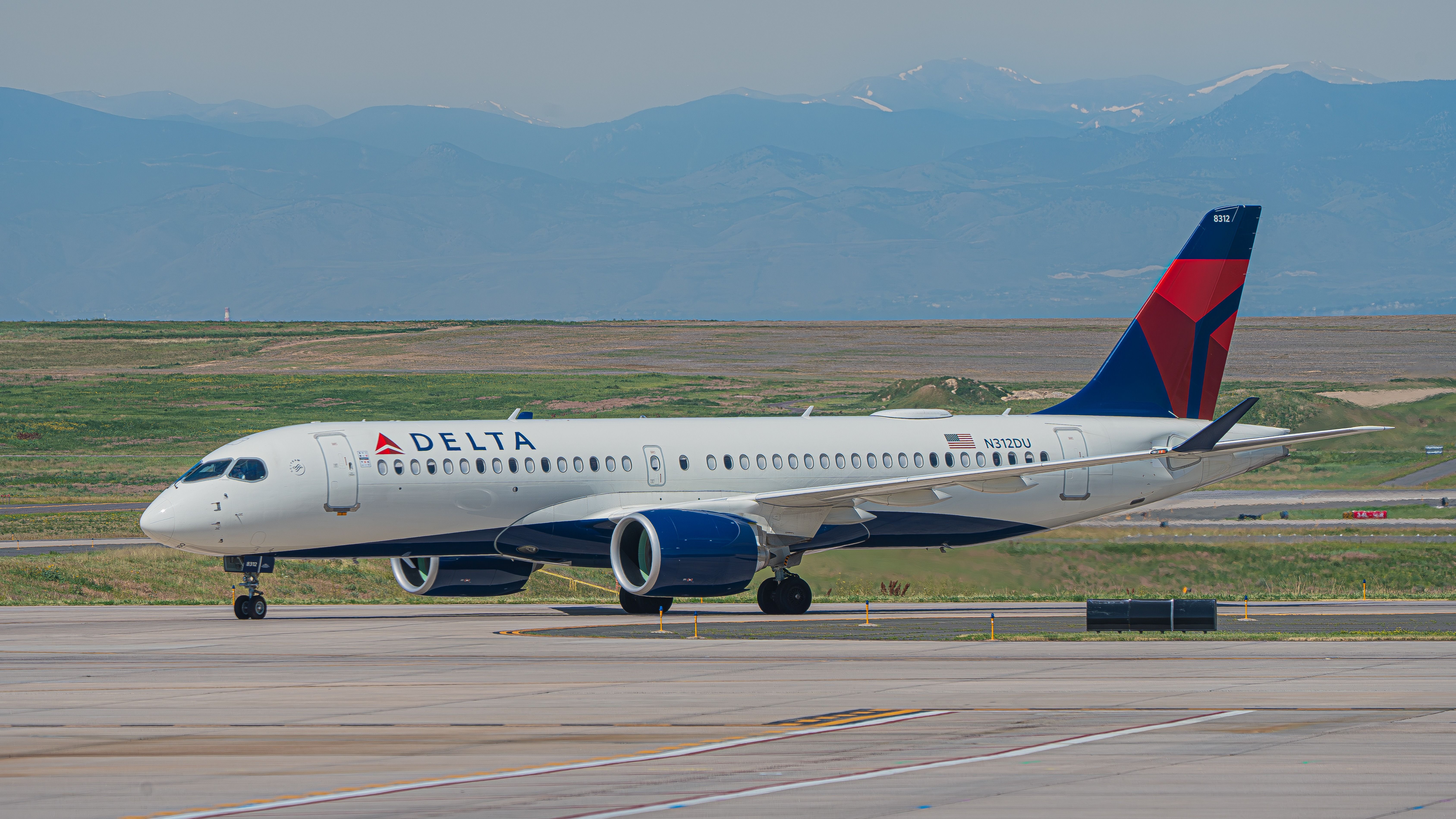 A Delta Air Lines Airbus A220-300 (N312DU) taxis into Denver International Airport, July 2023.