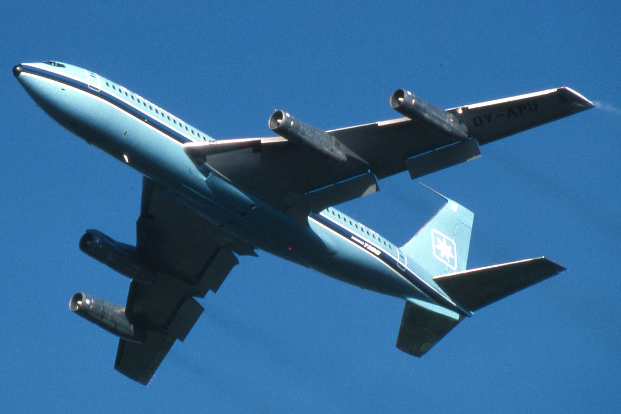 A Maersk Boeing 720 flying in the sky.