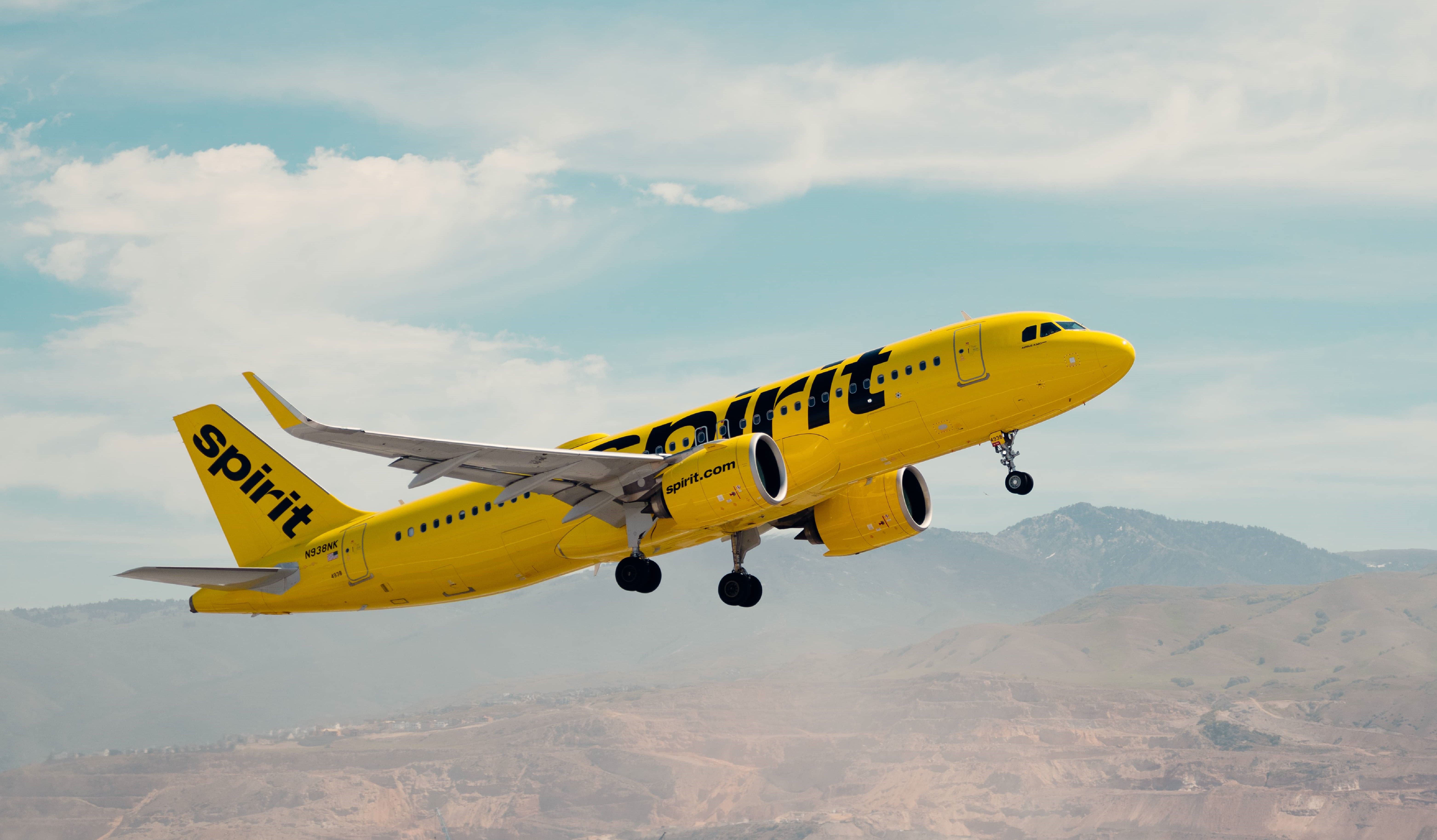 A Spirit Airlines Airbus A320 flying in the sky.