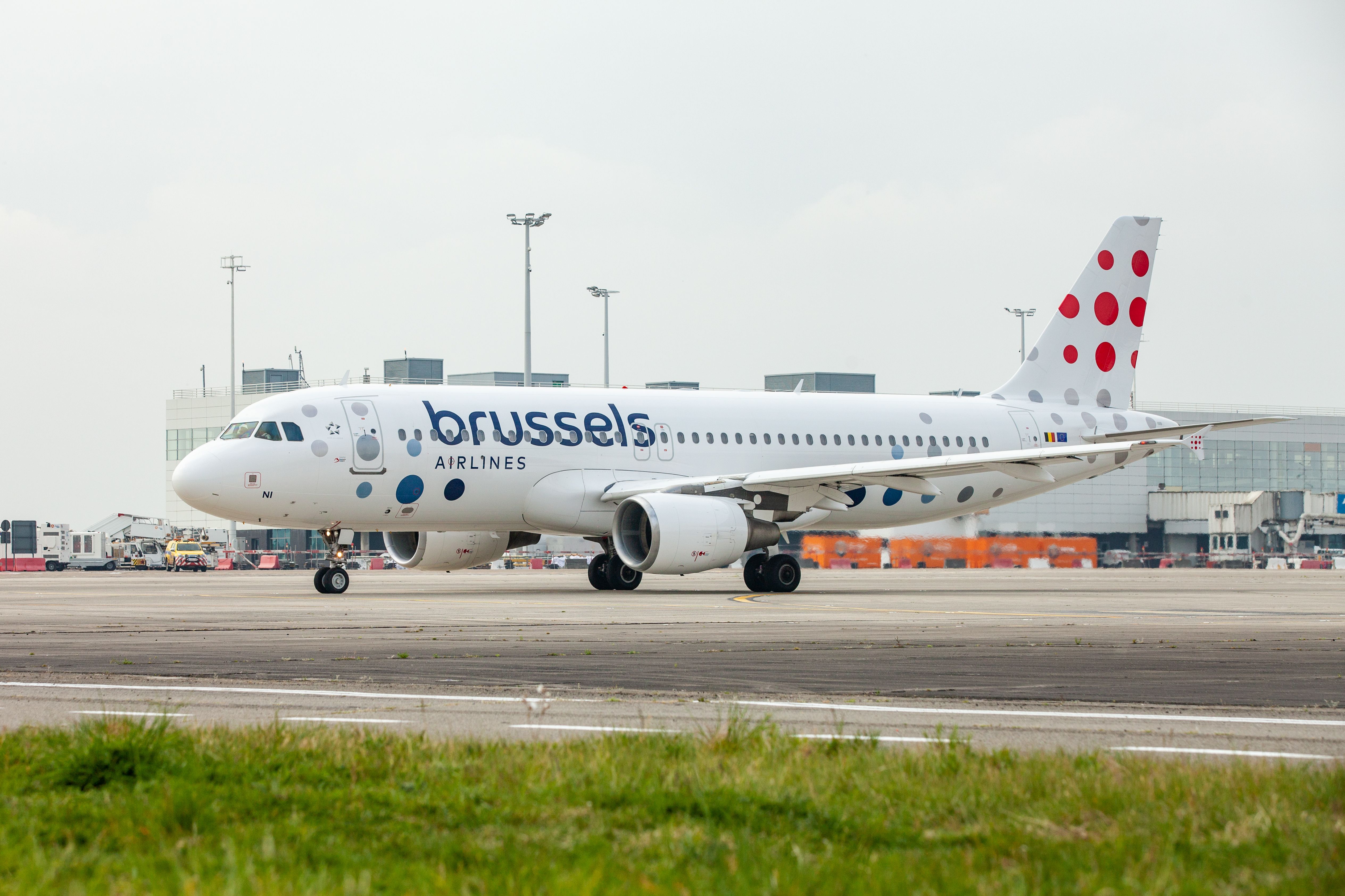 A Brussels Airlines Airbus A320 Taxiing on an airport apron.