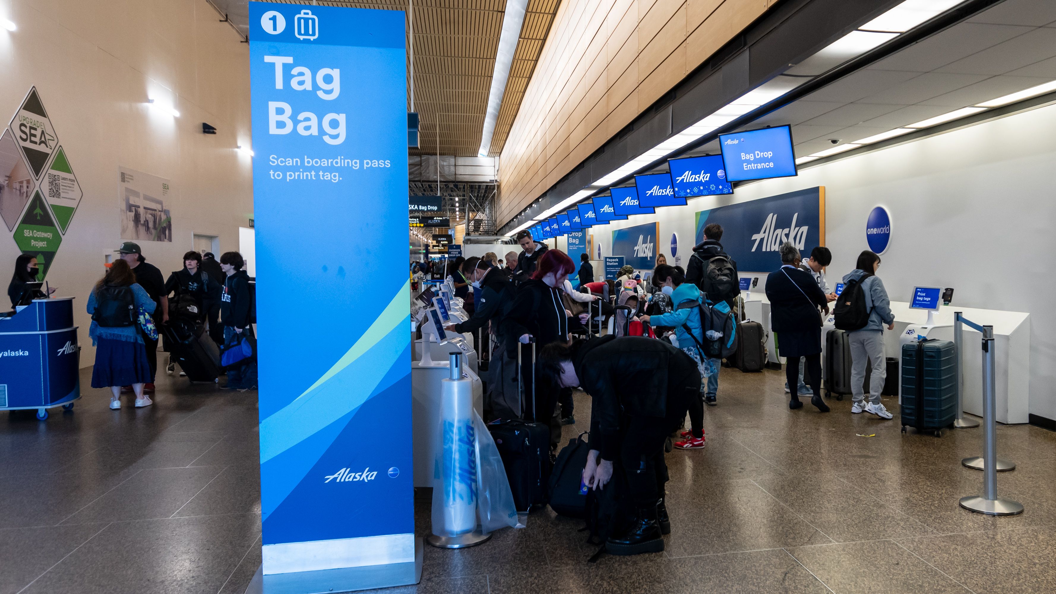 Passengers at Alaska Bag Drop at SEA During SEA Gateway Project