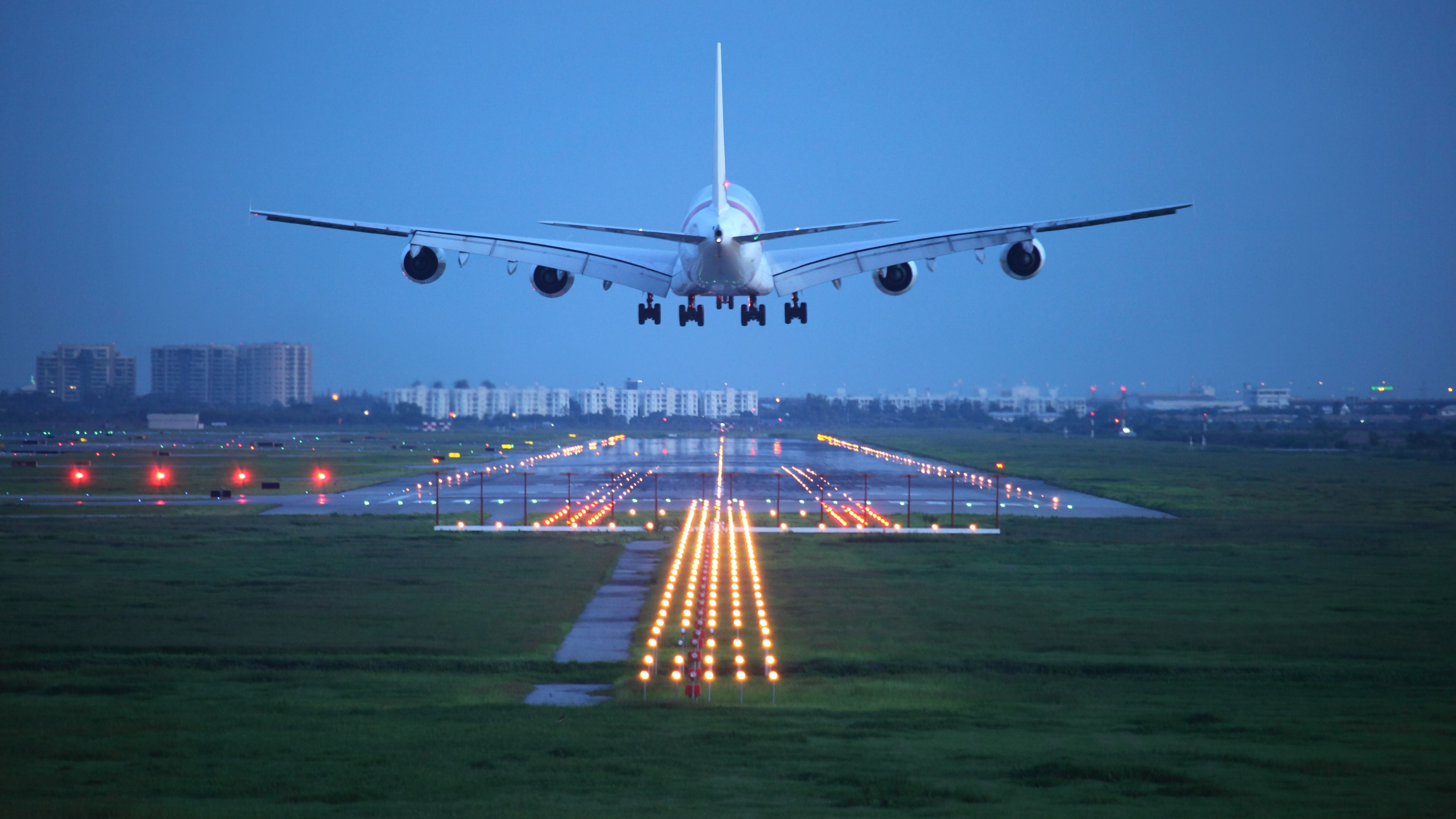 An Airbus A380 about to land on a runway.