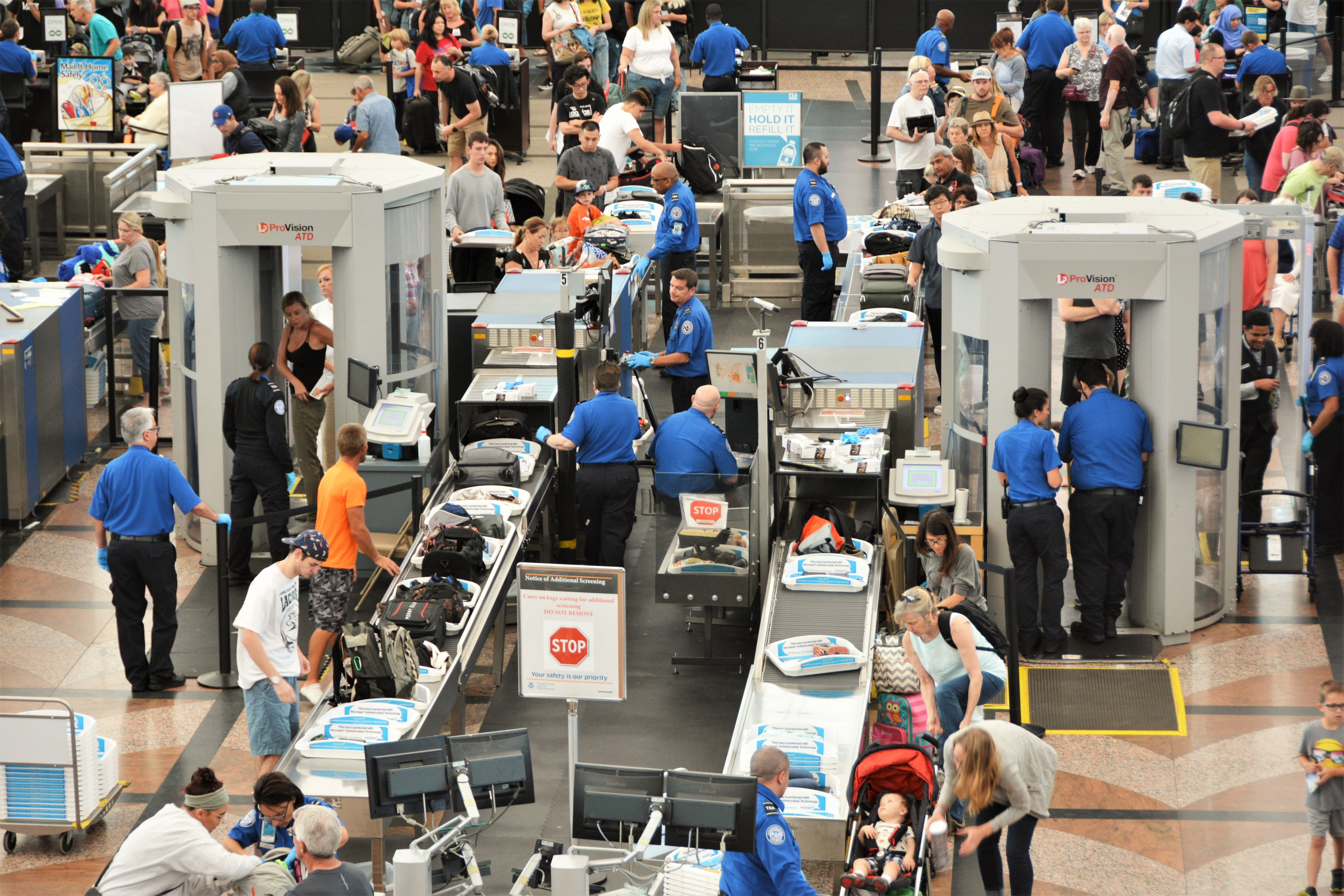 Travelers in long security lines at Denver International Airport.
