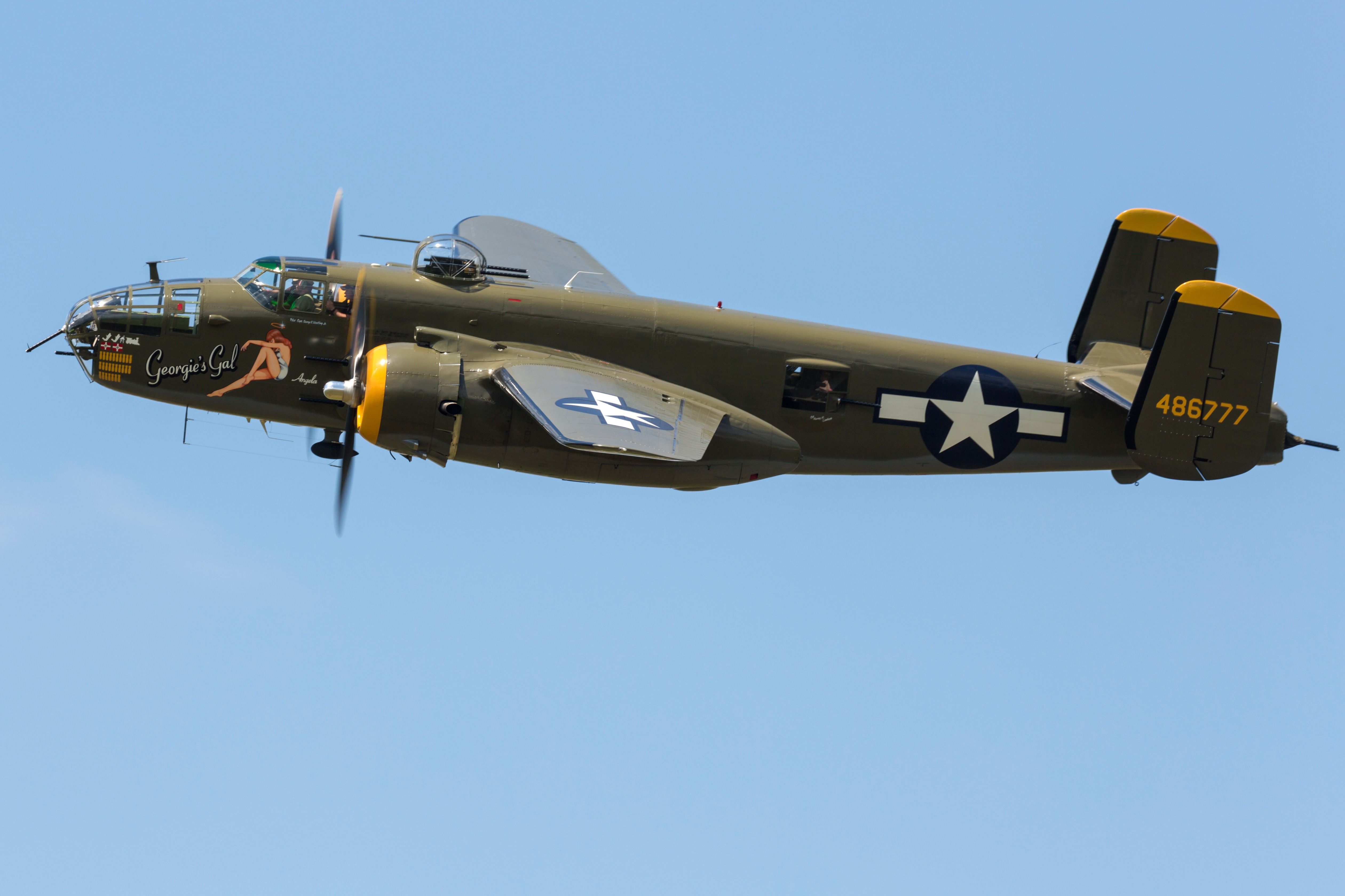 A World War II era B-25 Mitchell flying in the sky.