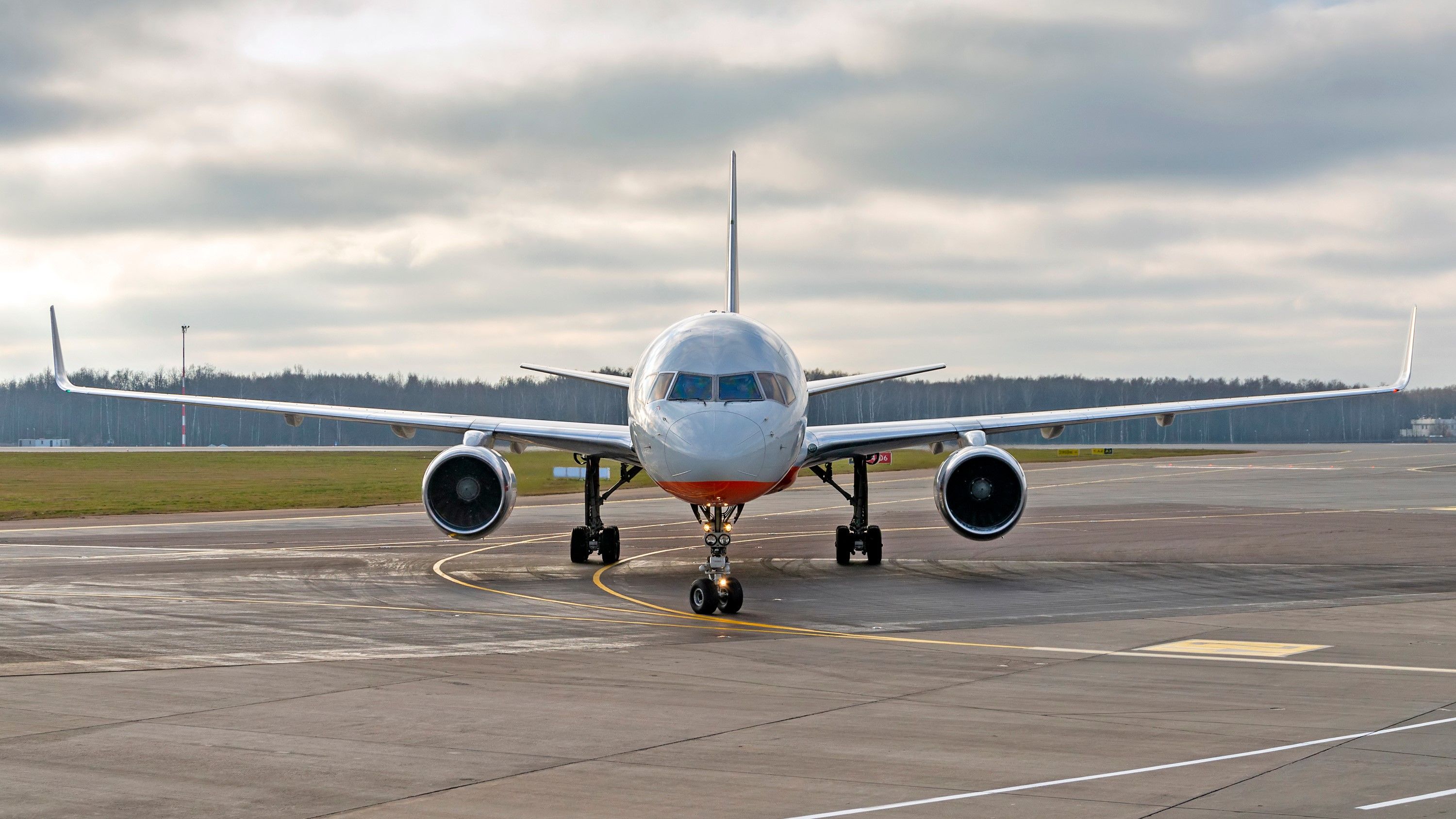 A head on view of a Boeing 757 on an airport apron.