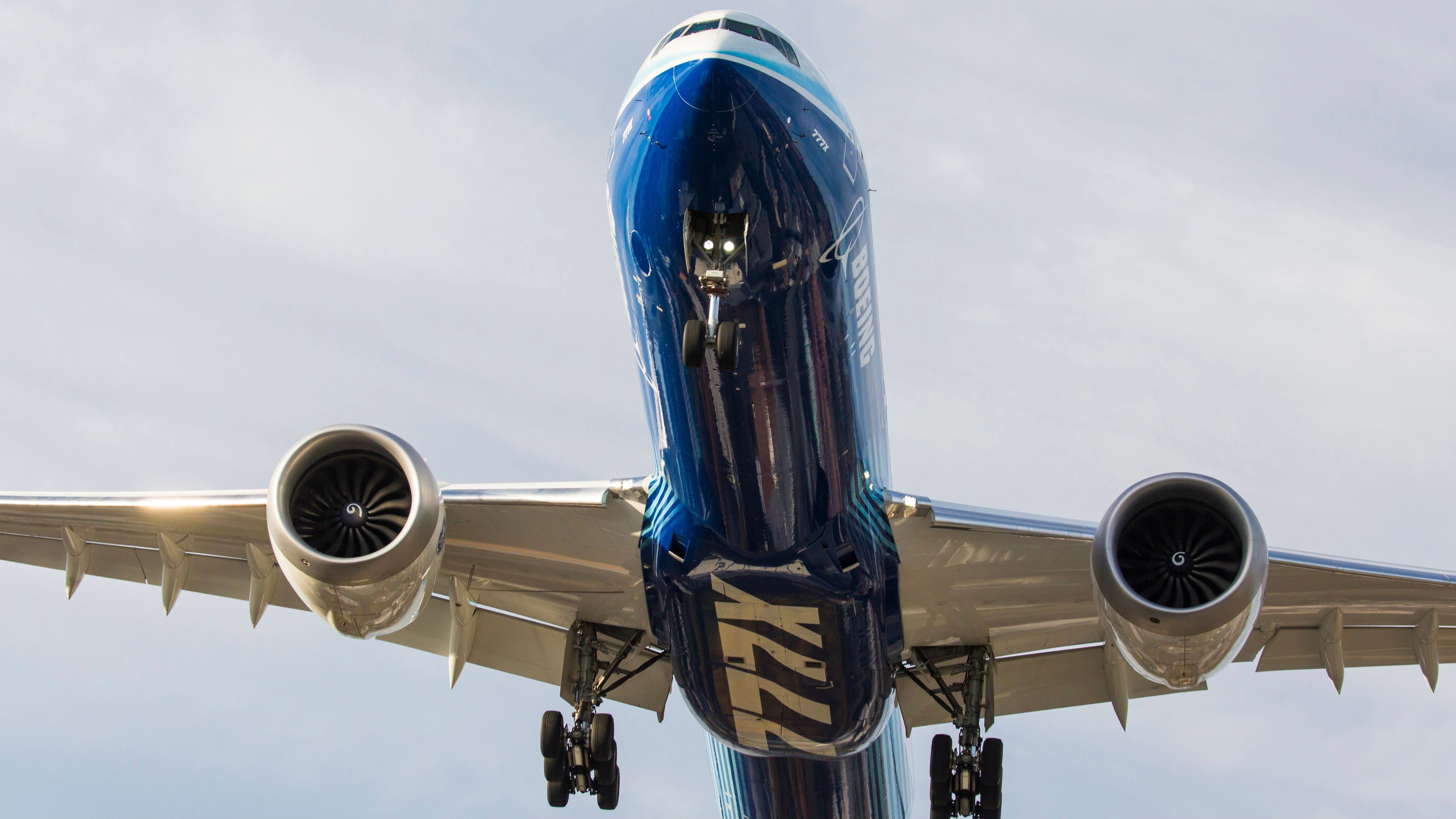 A Boeing 777X flying overhead.