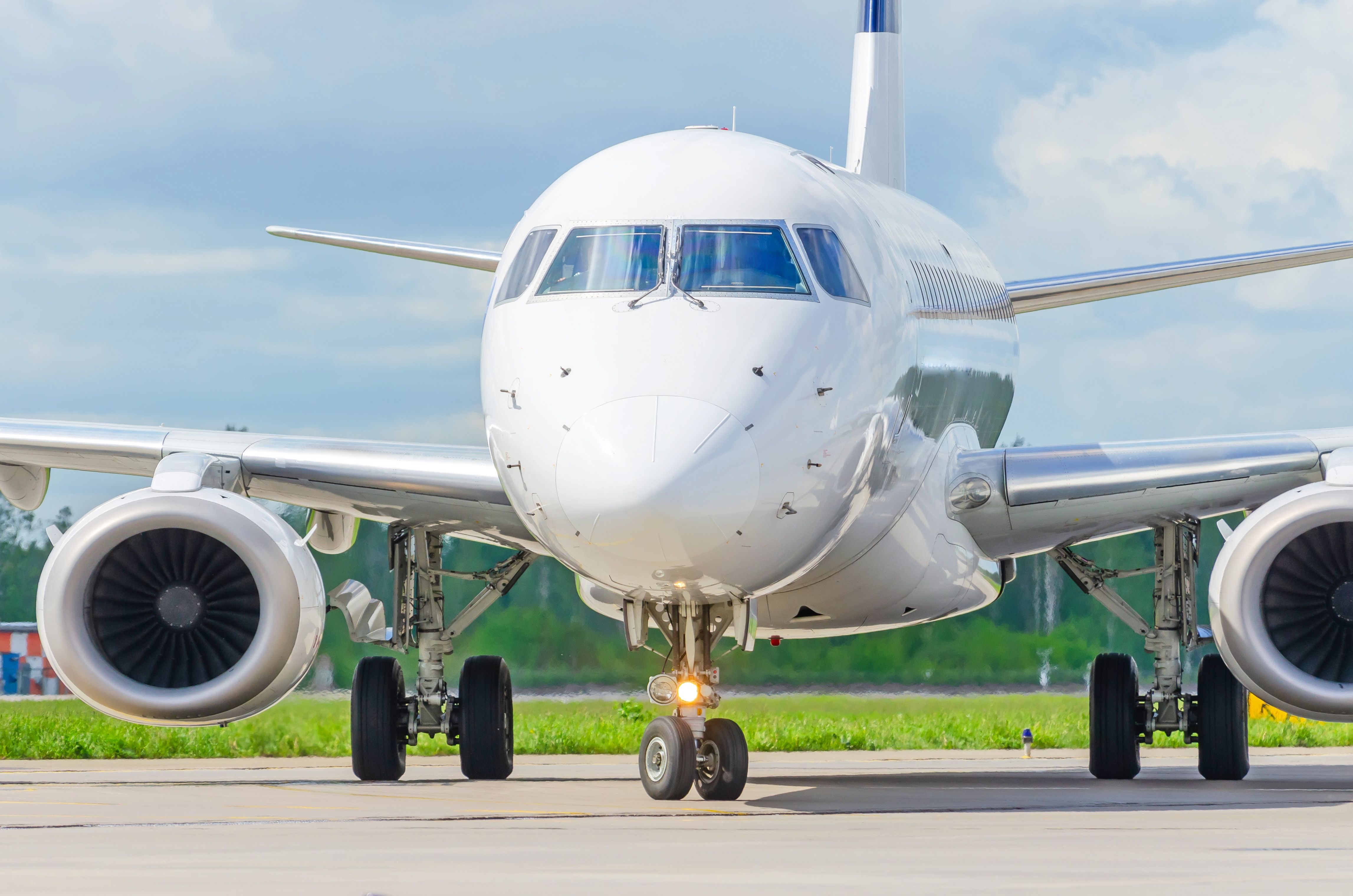 An Embraer E-jet with its nose wheel turned.