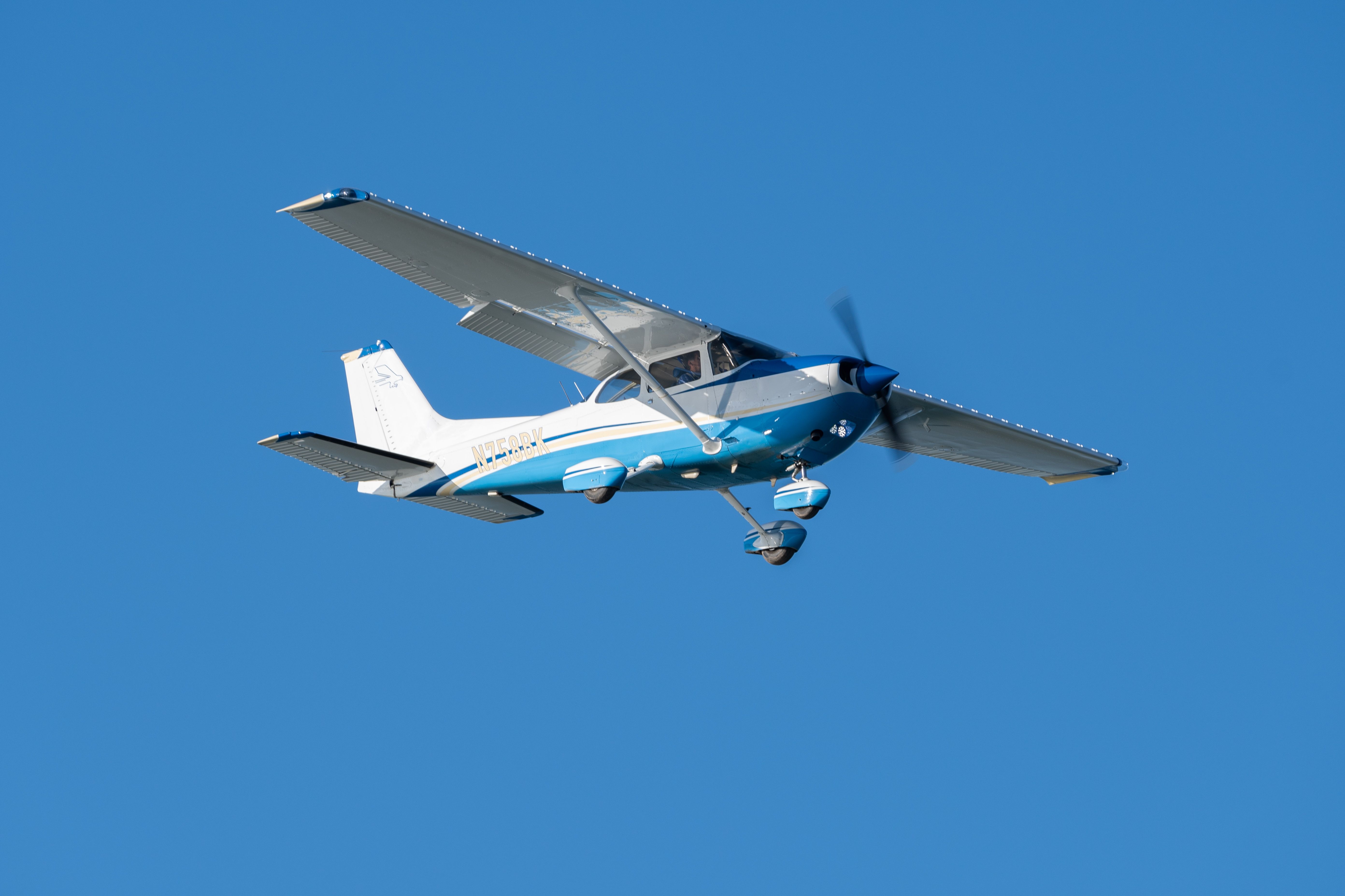 A Cessna 172 flying in the sky.