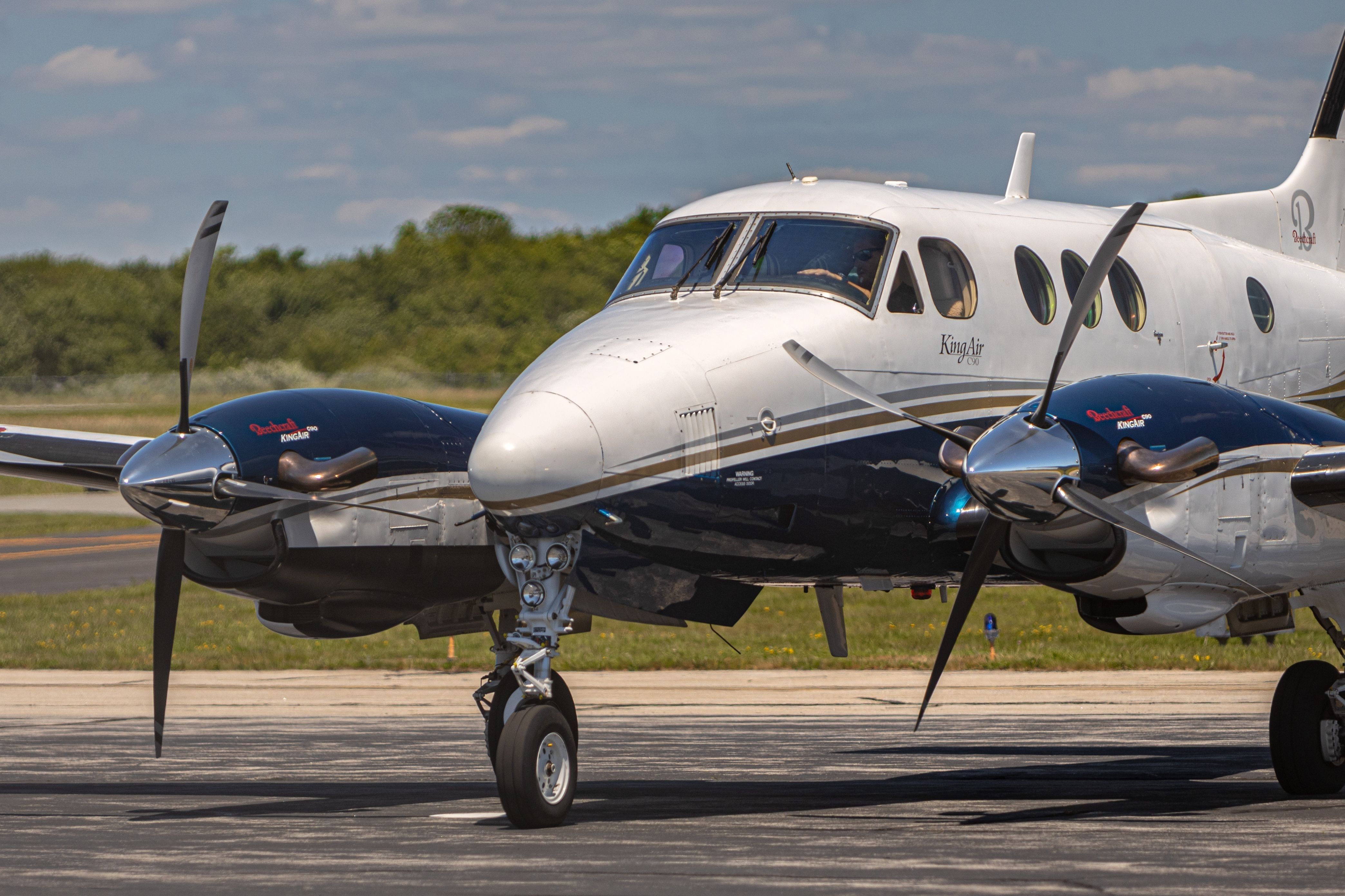 A Beechcraft King Air aircraft parked on an airport apron.