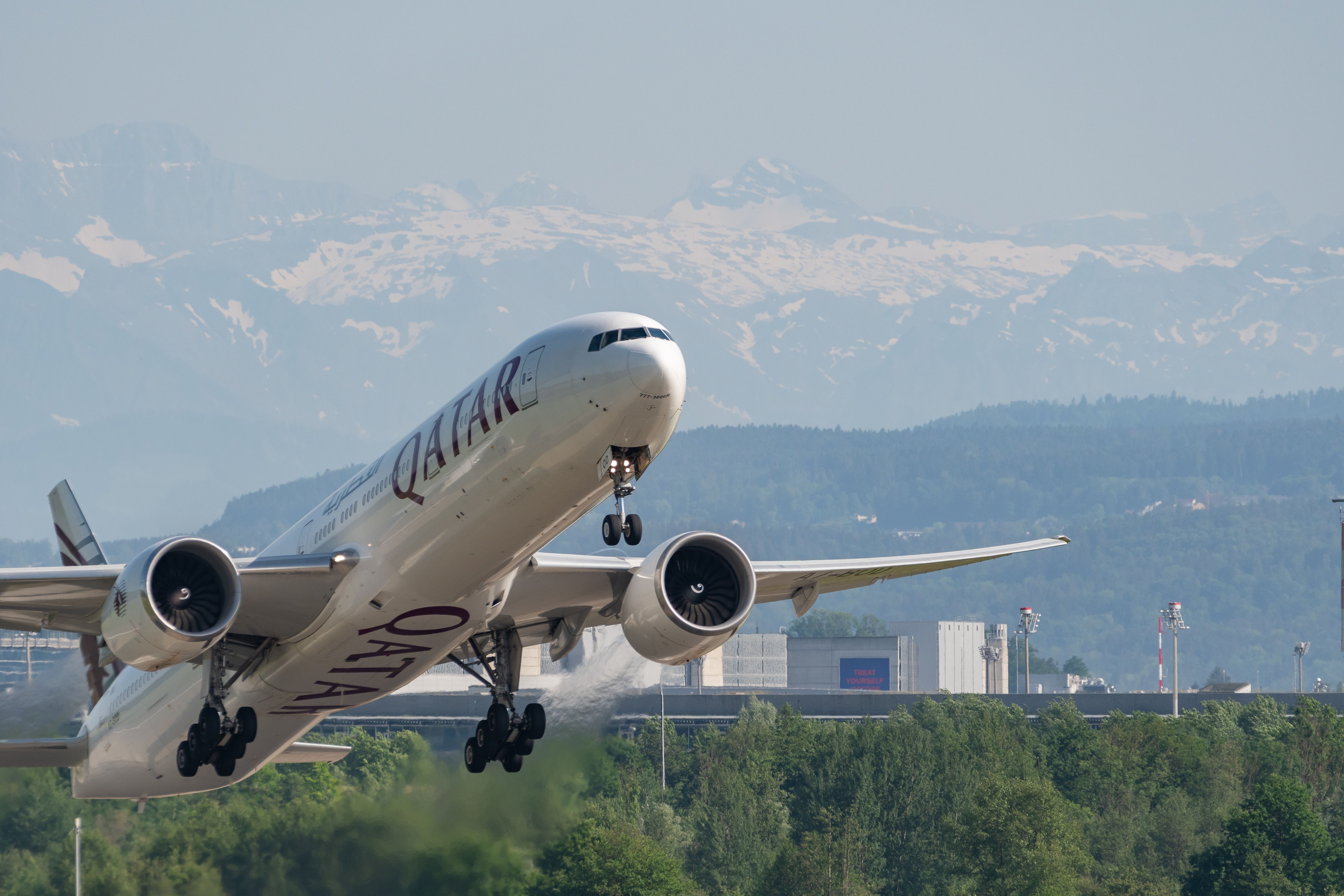 Qatar Airways Boeing 777 taking off from Switzerland.