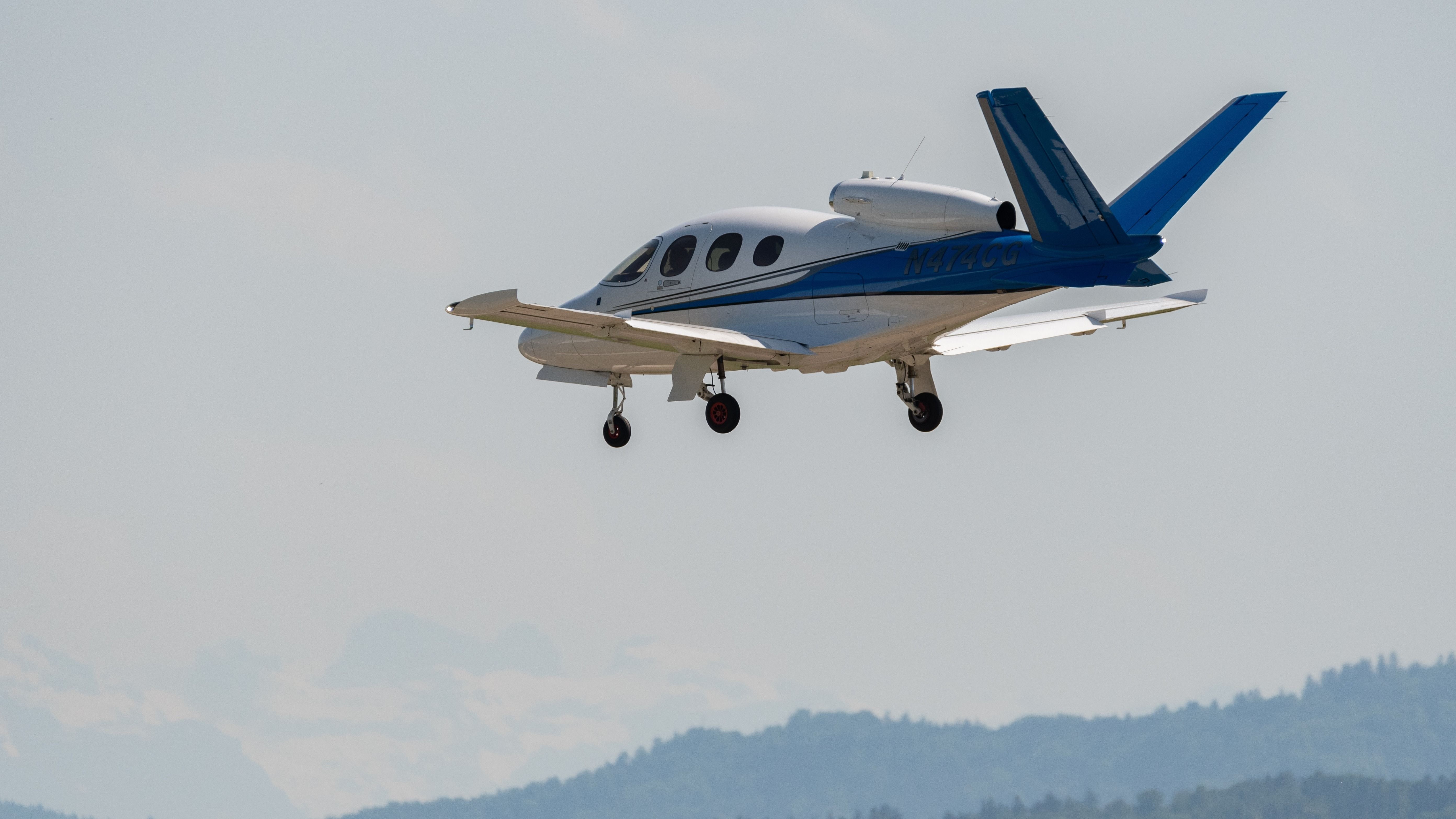 The Cirrus Vision Jet flying in the sky.