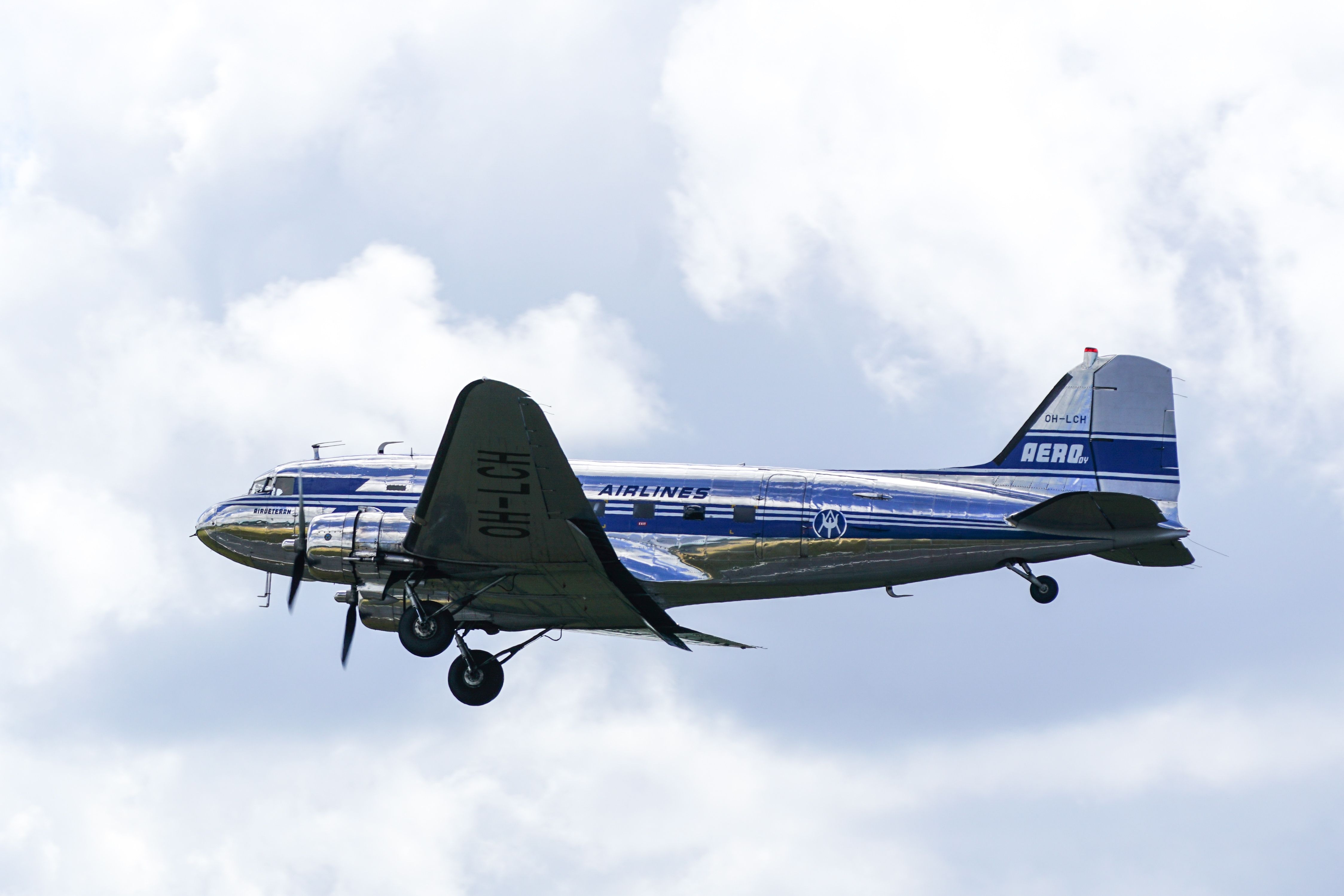 A Douglas DC-3 flying in the sky.