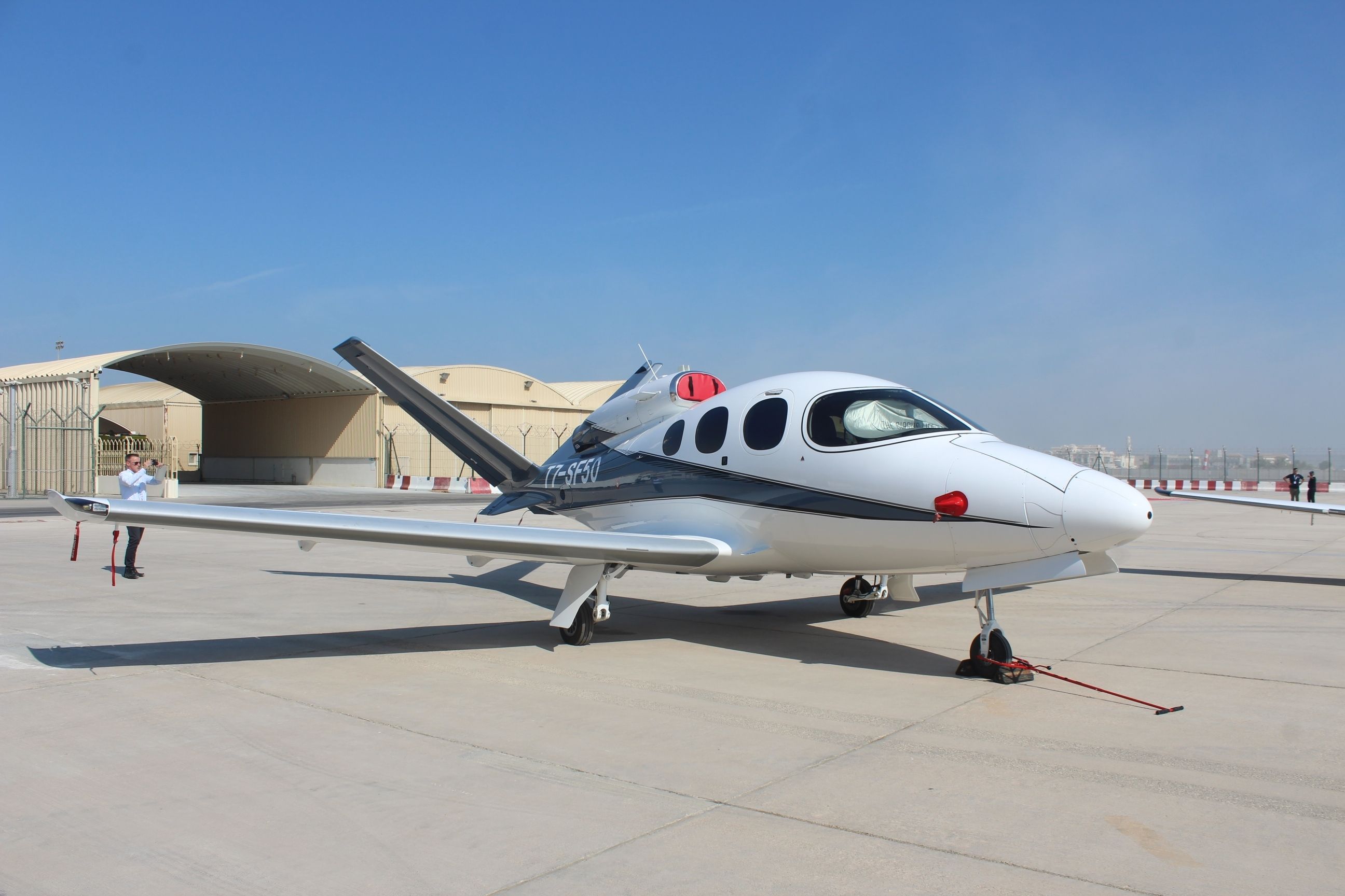 A Cirrus Vision Jet parked at an airport.