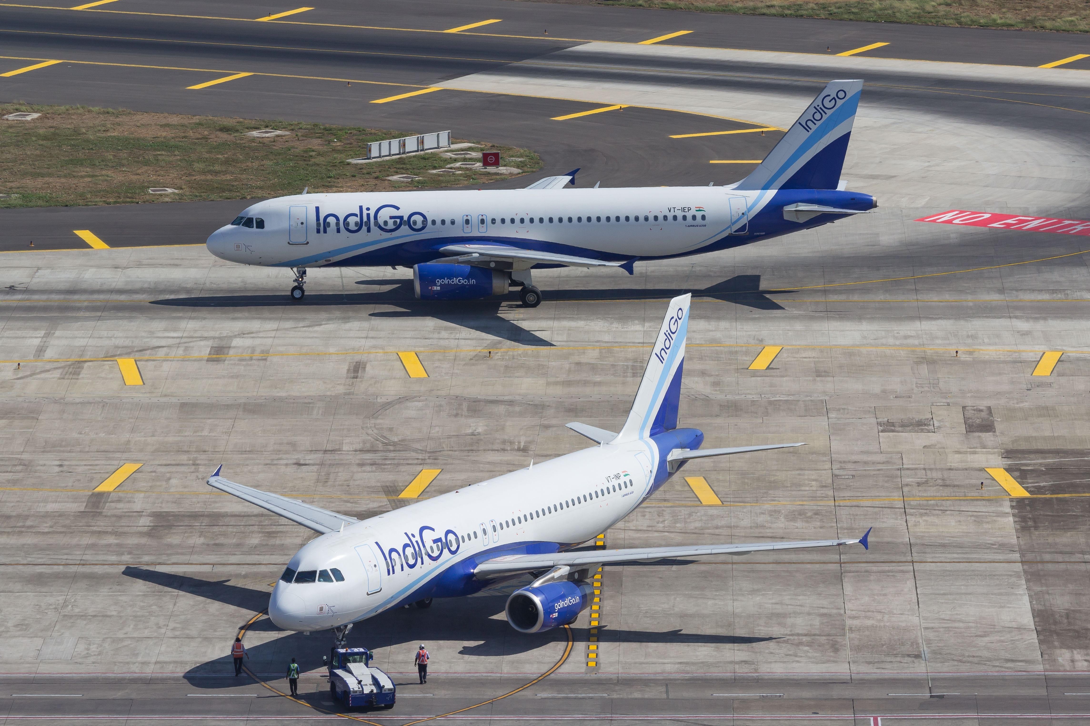 Two IndiGo Airbus A320 aircraft on an airport apron.