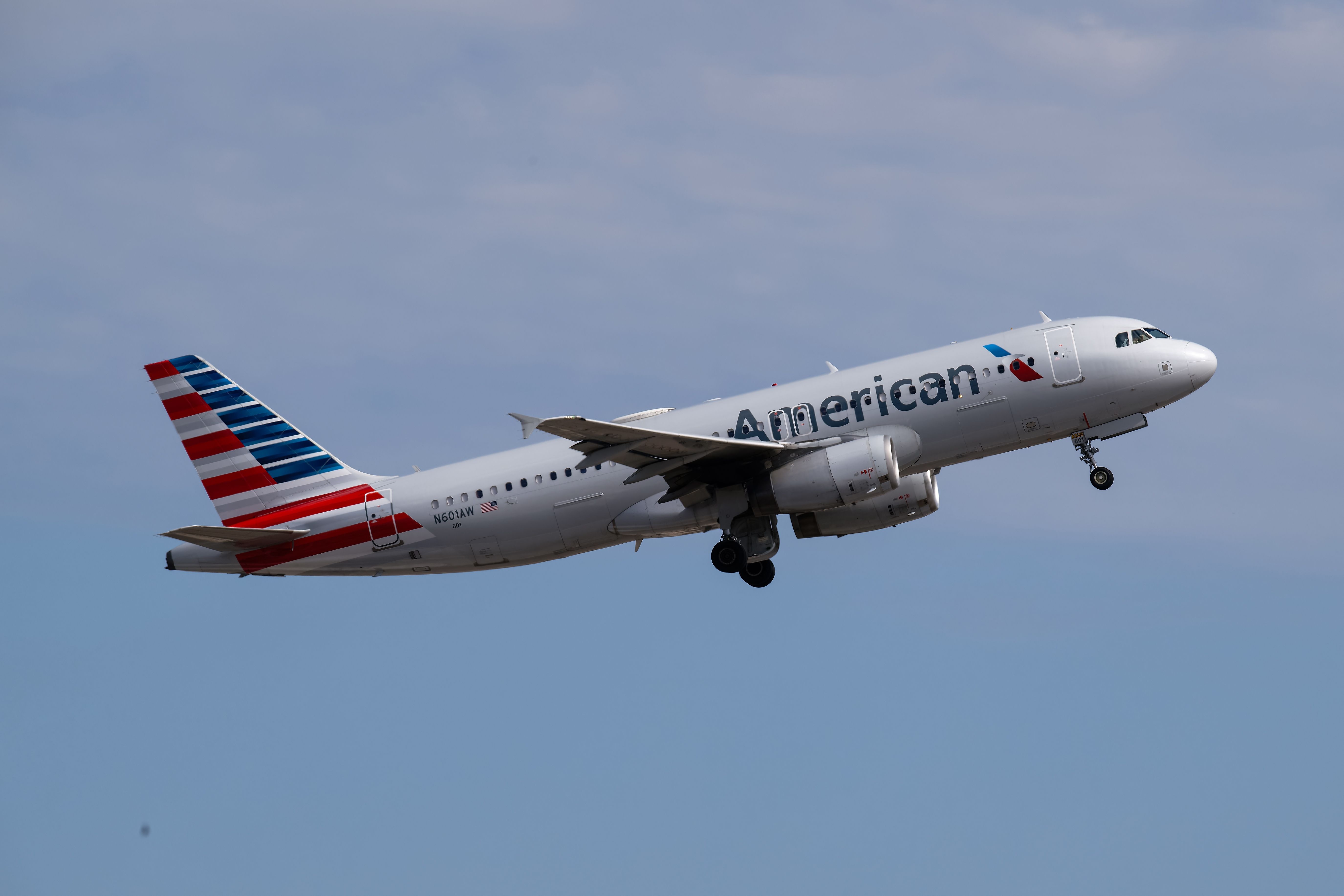 An American Airlines aircraft flying in the sky.