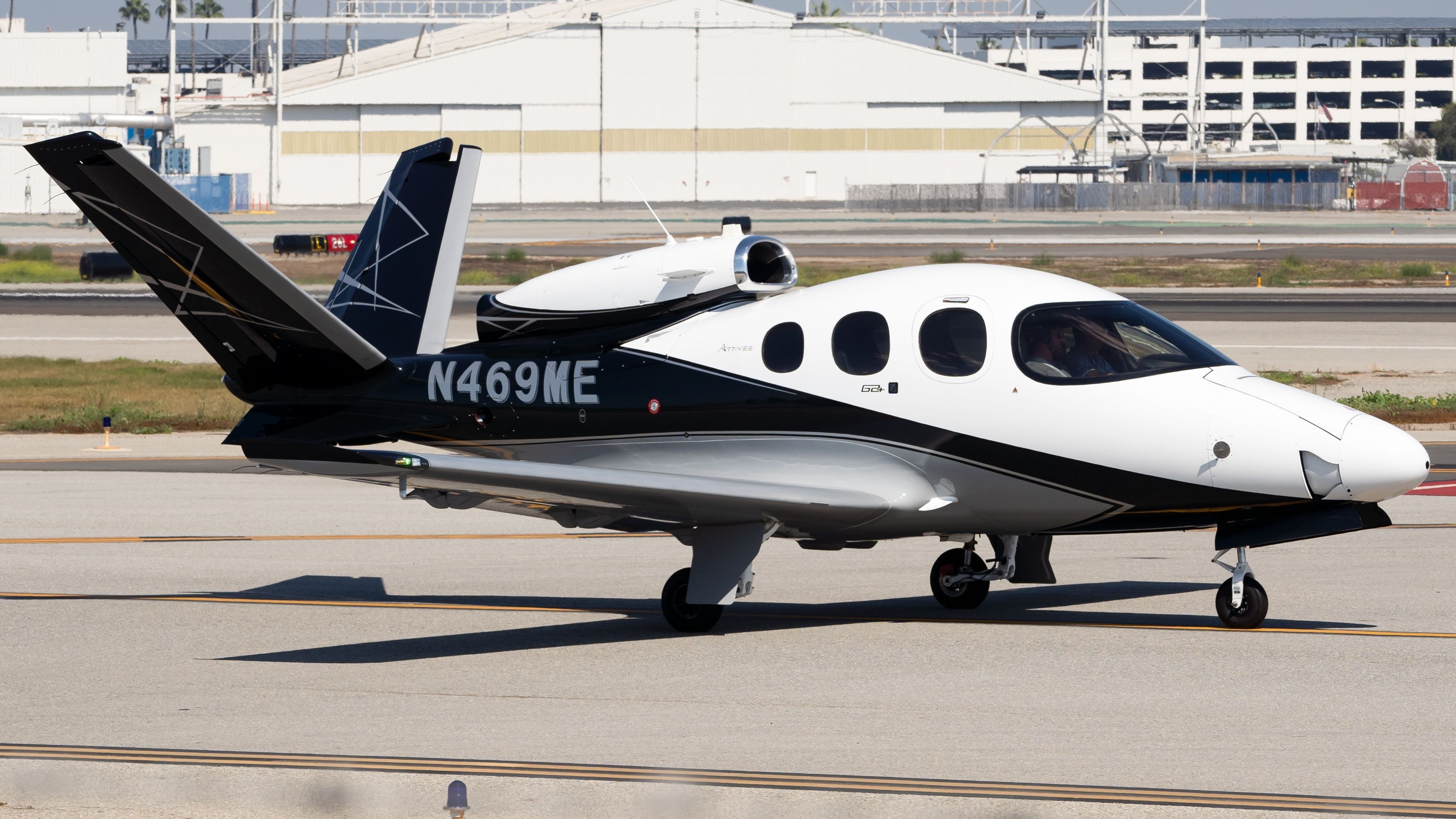 A Cirrus Vision Jet parked at an airport.