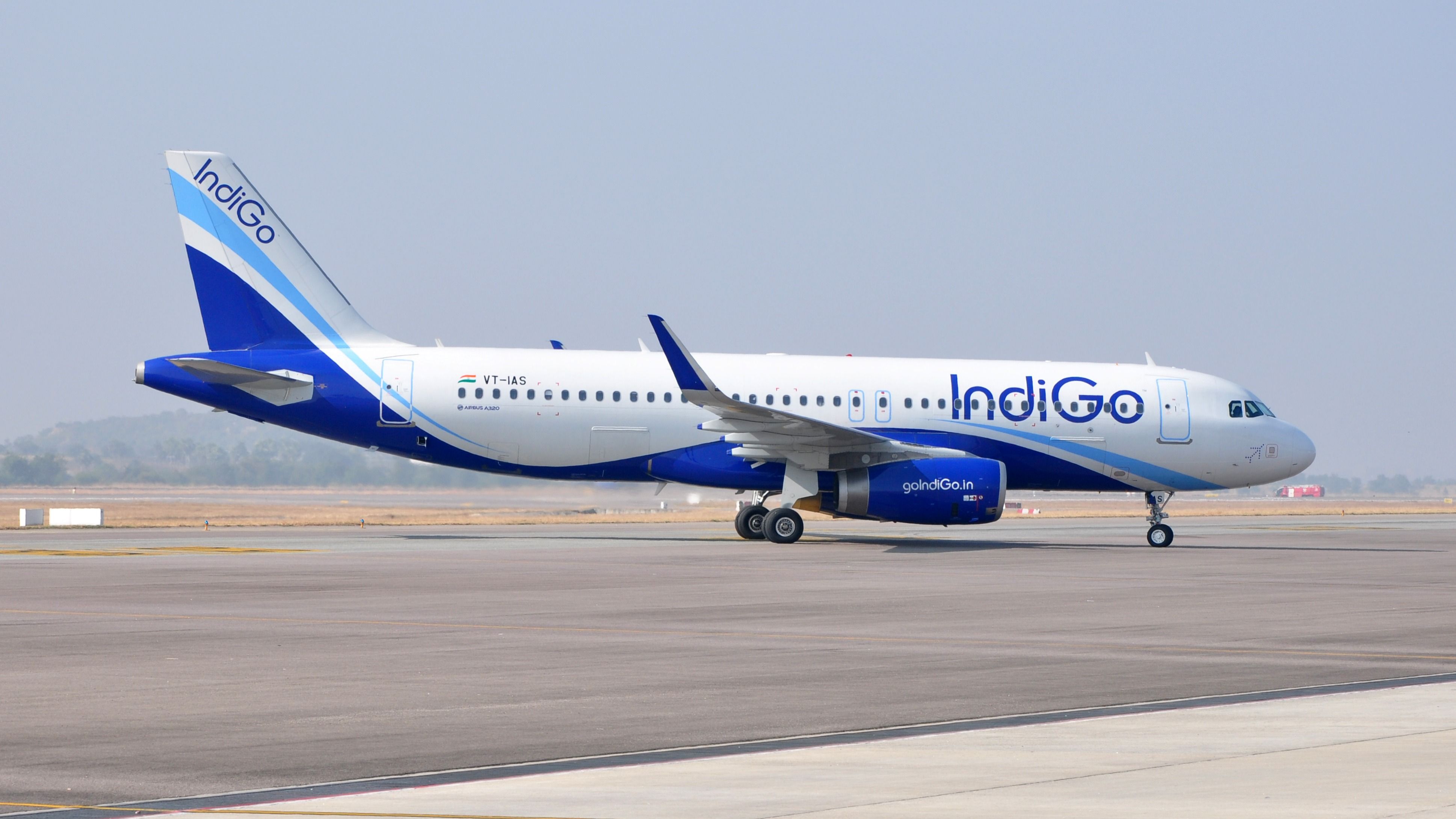 An IndiGo aircraft on an airport apron.