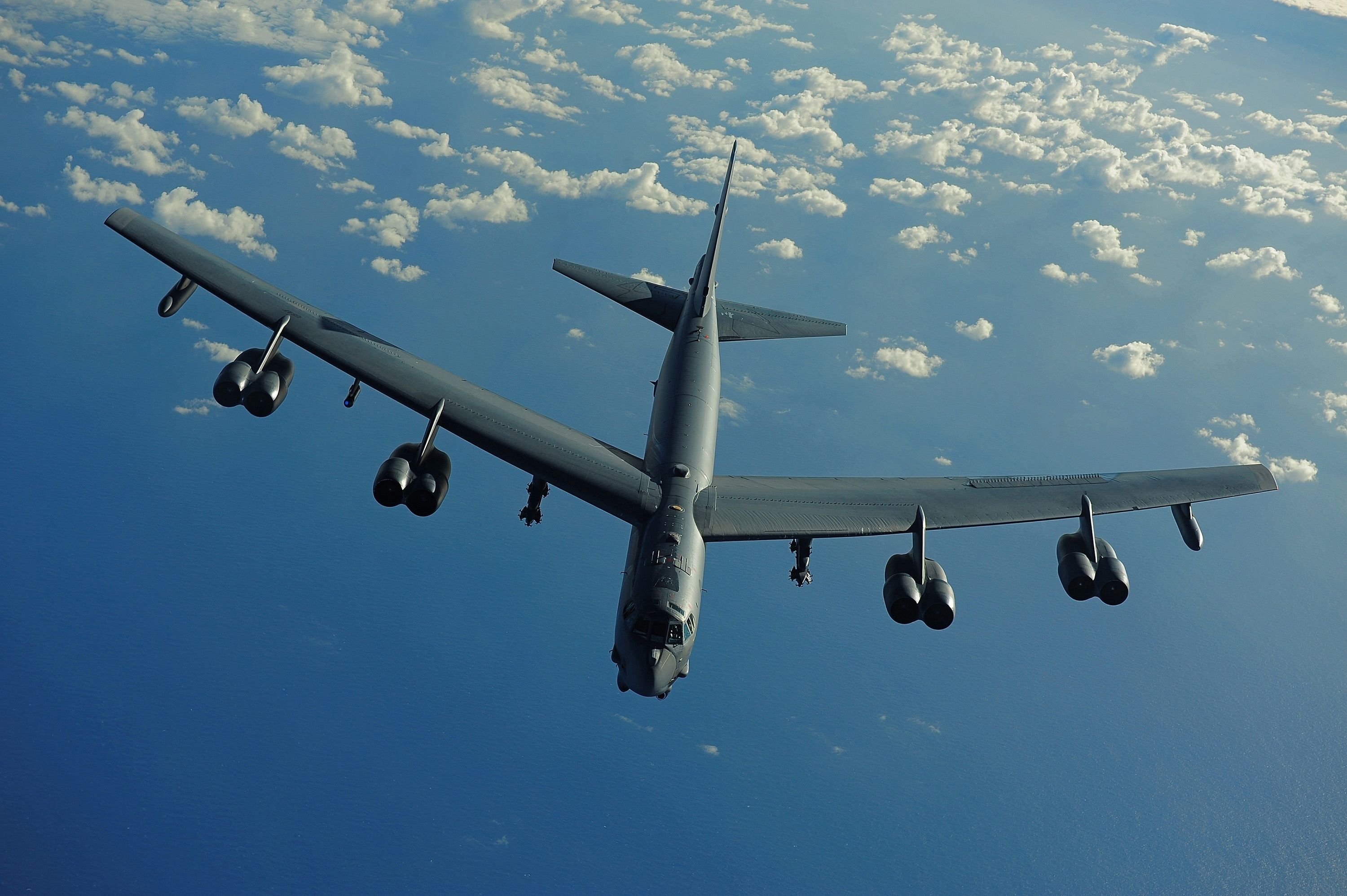 A B-52 flying over water.