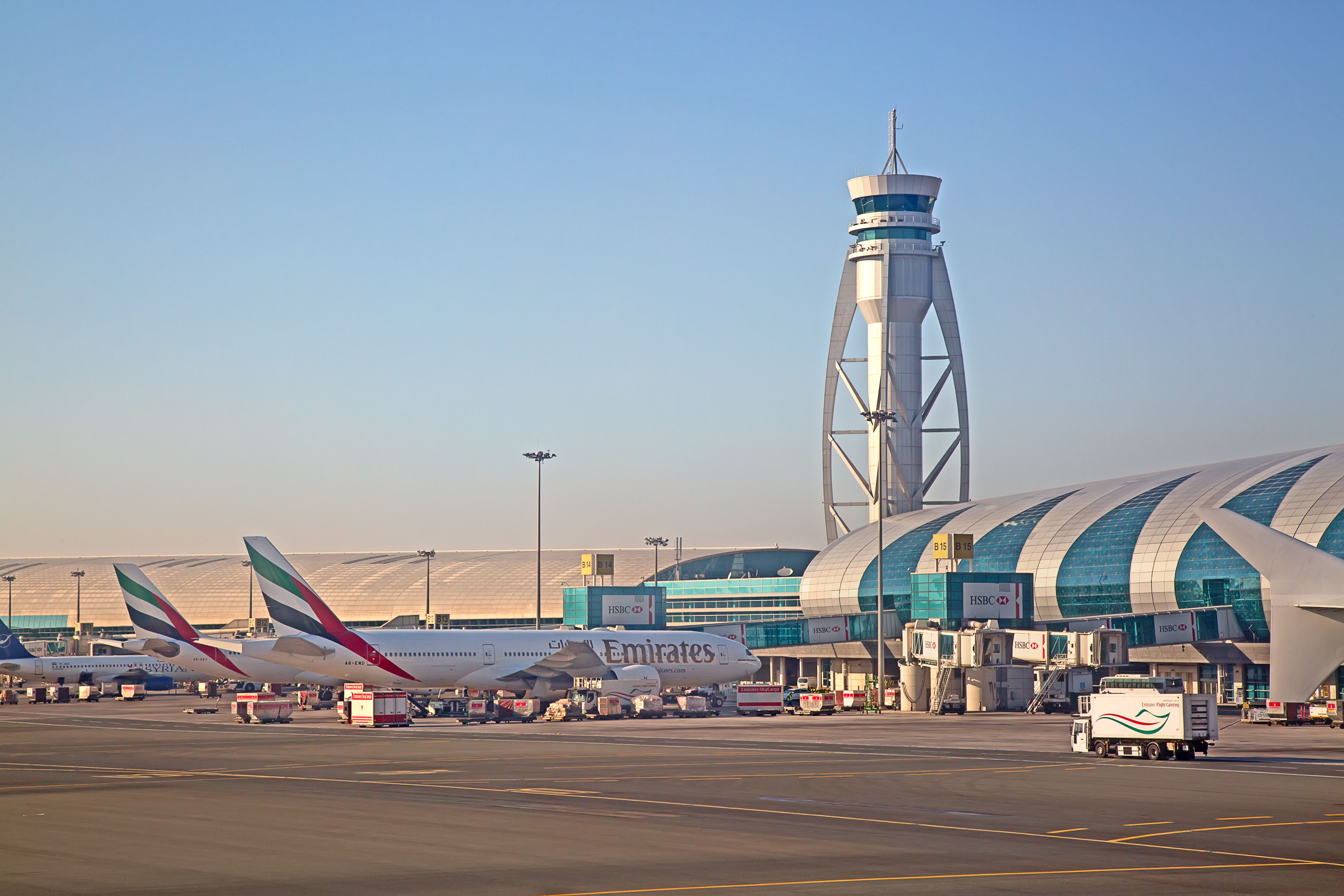 Two Emirates Aircraft Parked At Gates At Dubai International Airport.