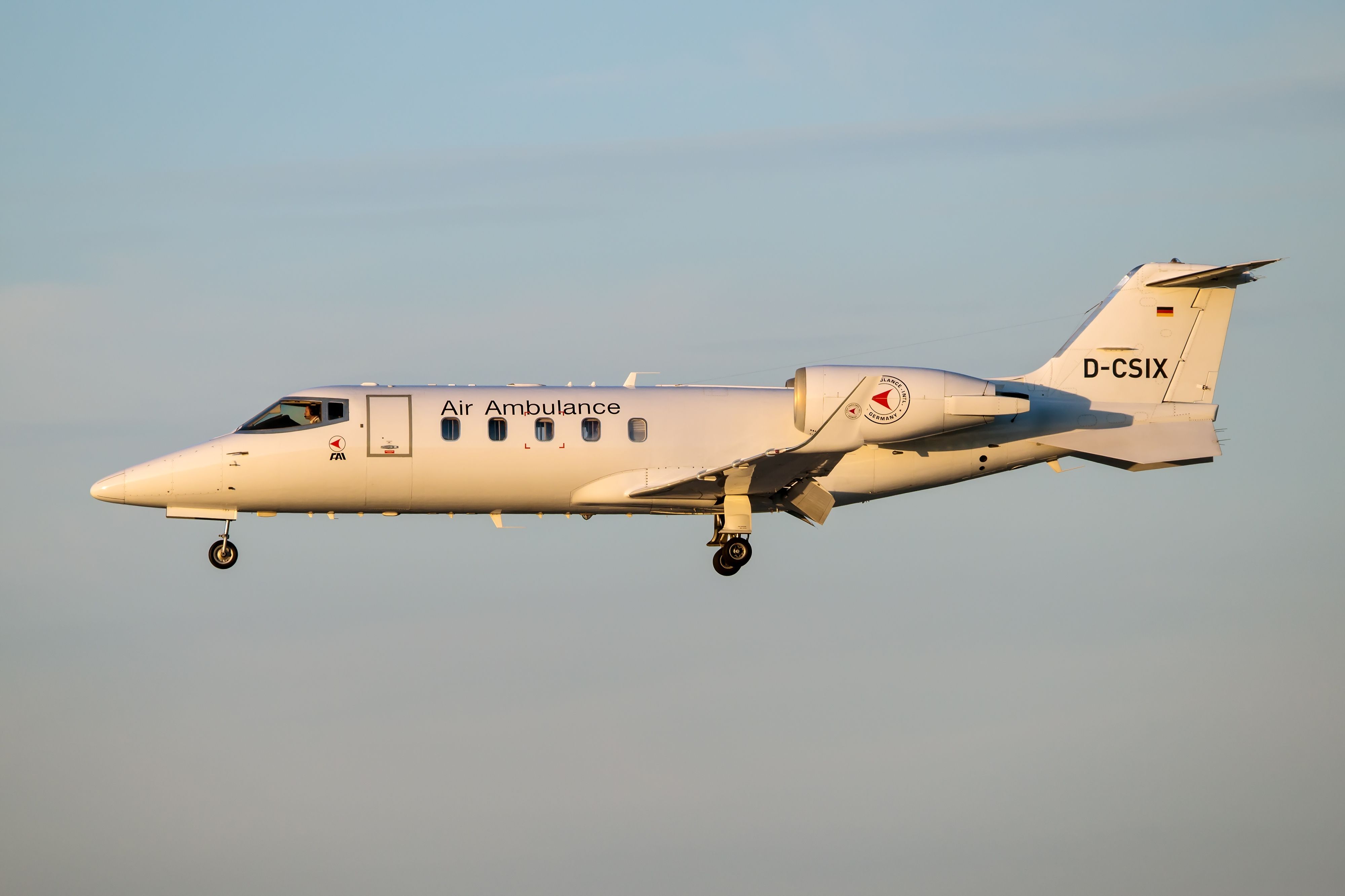 An Air Ambulance Learjet 60 flying in the sky.