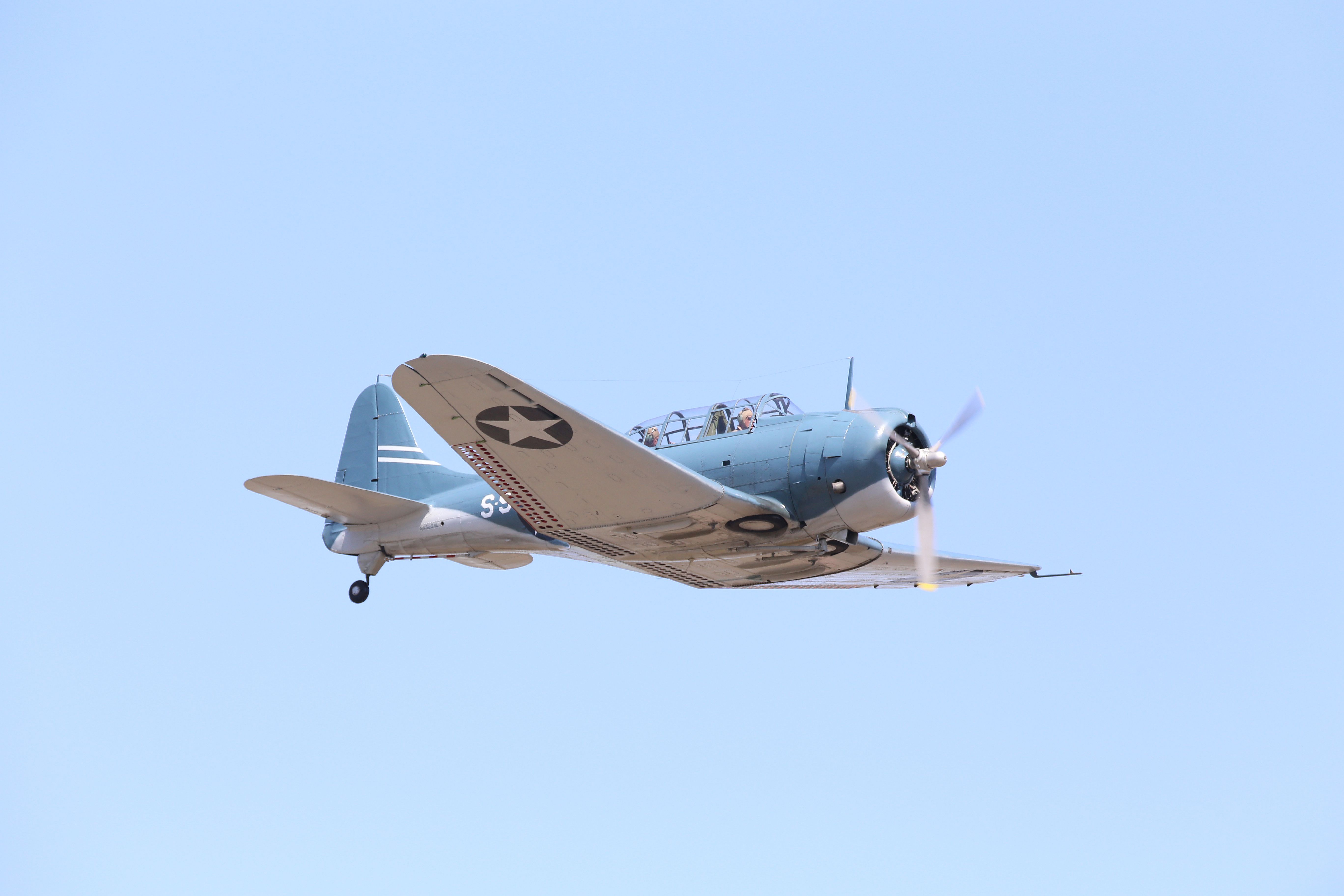 An SBD Dauntless Dive Bomber flying in the sky.