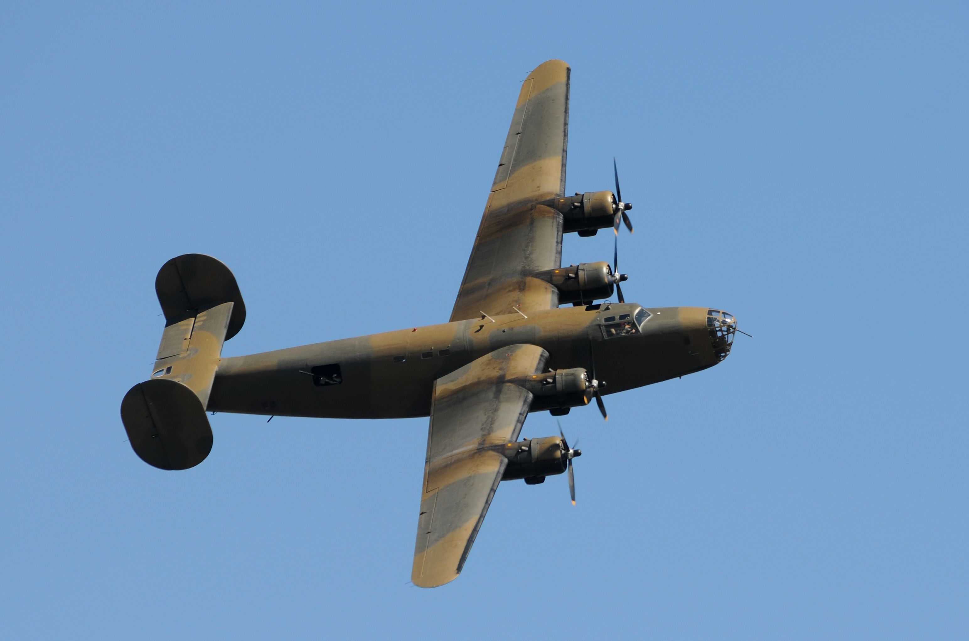 A B-24 Liberator flying in the sky.