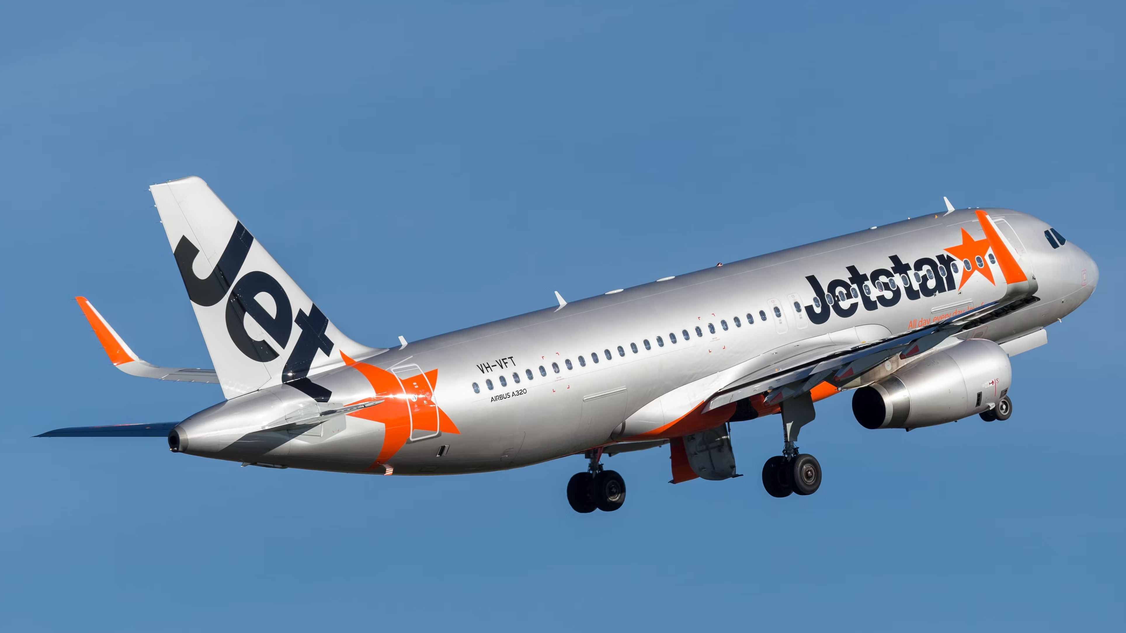 A Jetstar Airbus A321 flying in the sky.