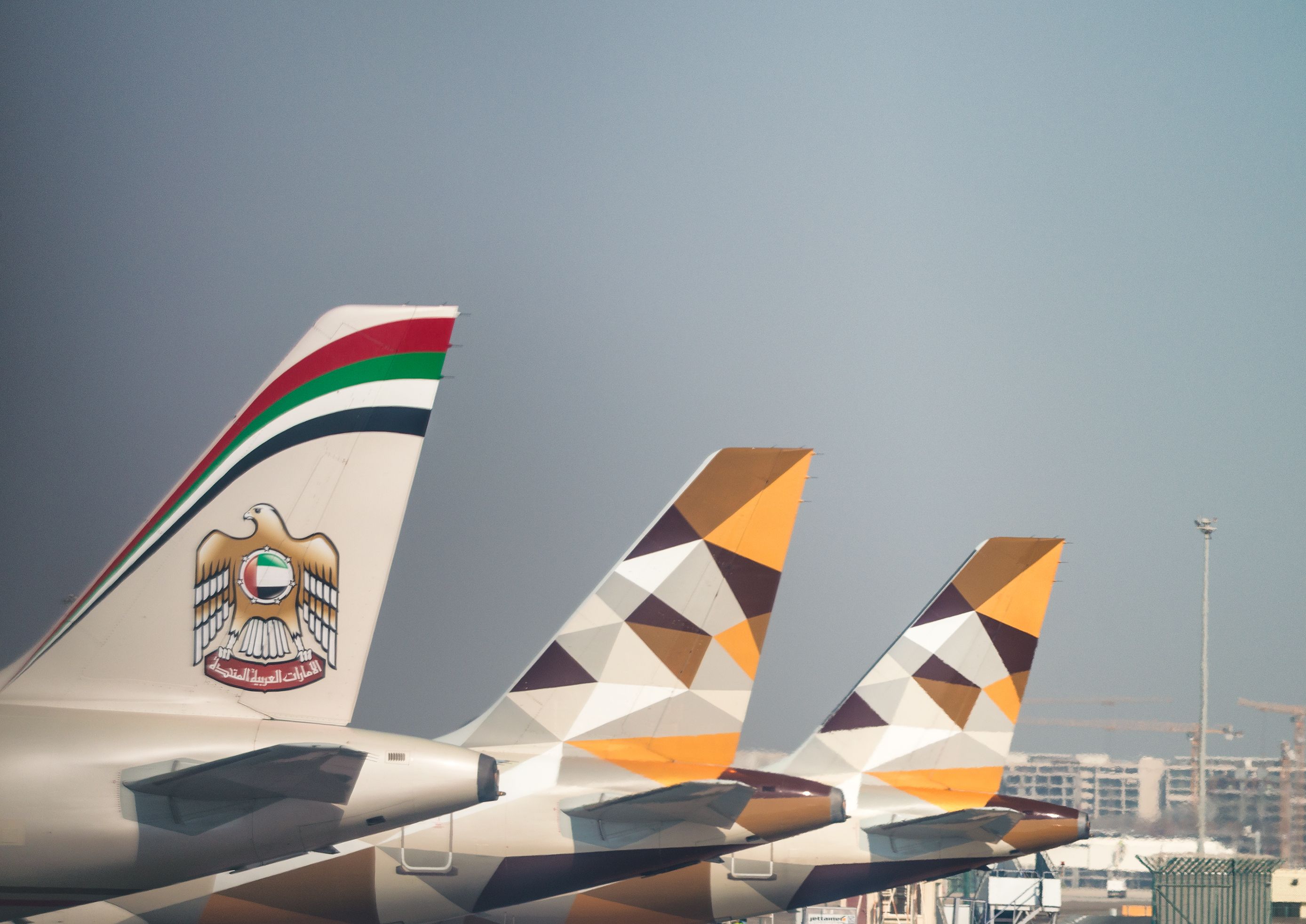 Aircraft tails of Emirates and Etihad Aircraft.
