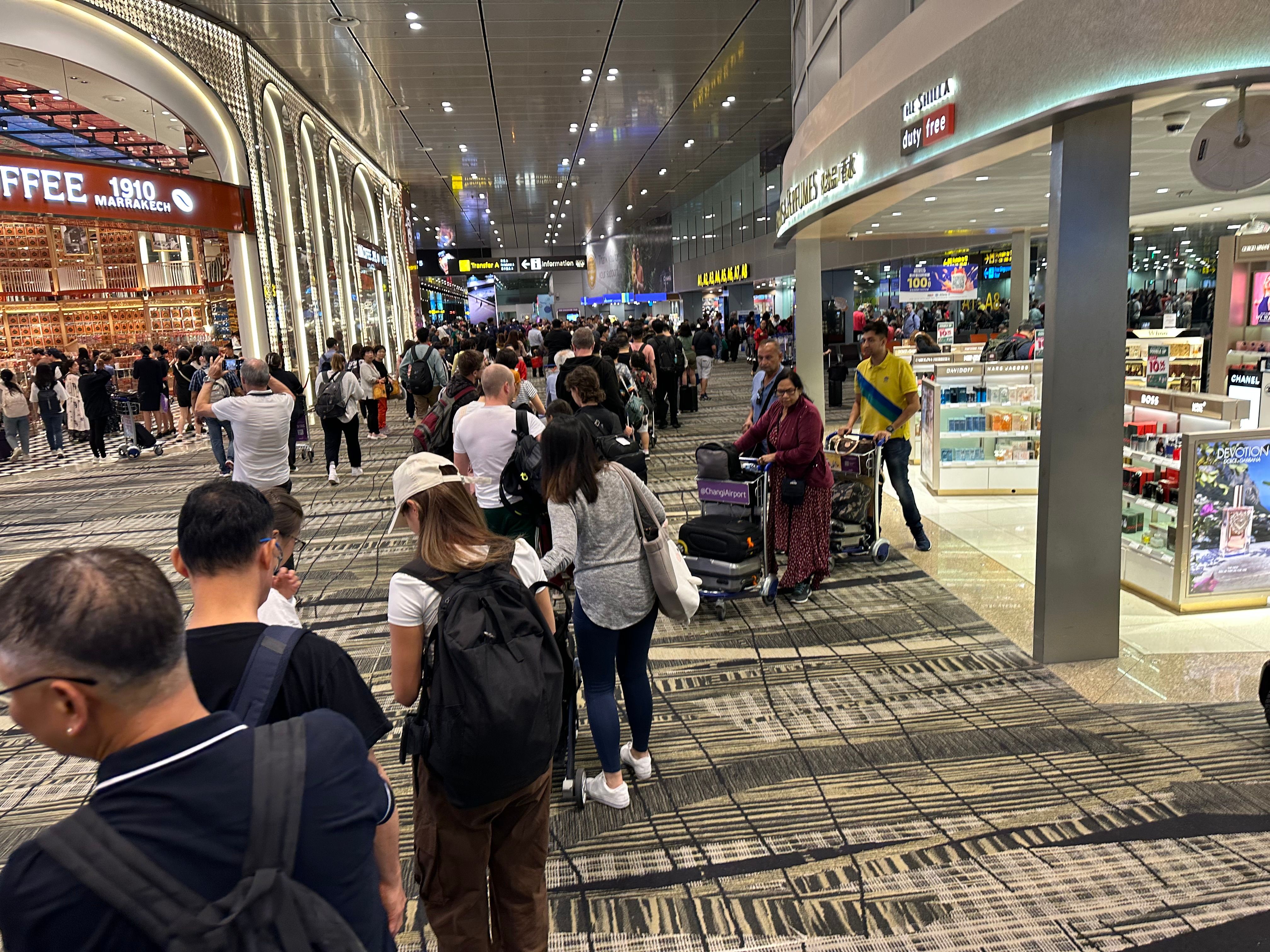 Waiting in line for security at Changi Airport in Singapore.