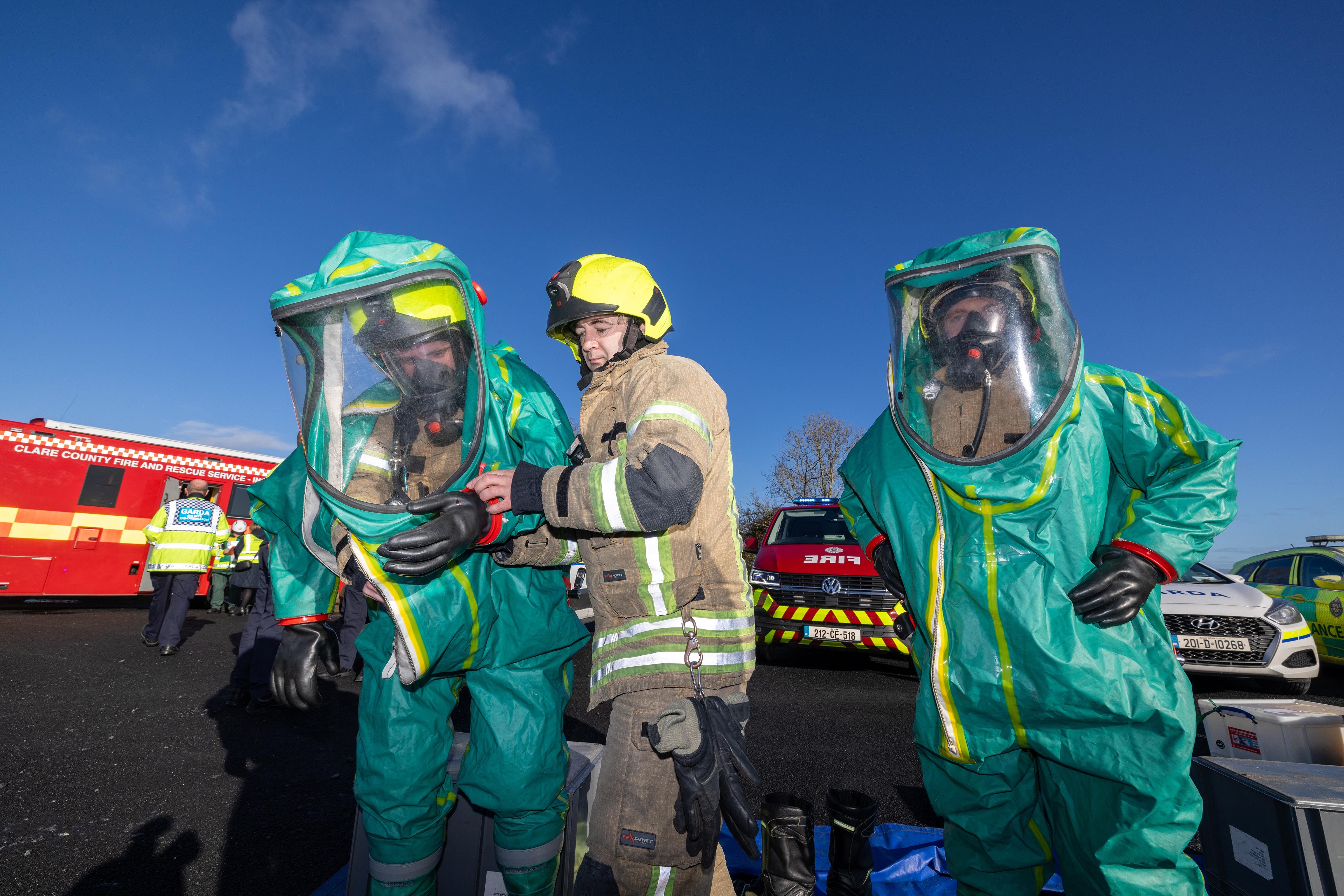 Emergency Services Workers Getting Reading In Protective Suits.