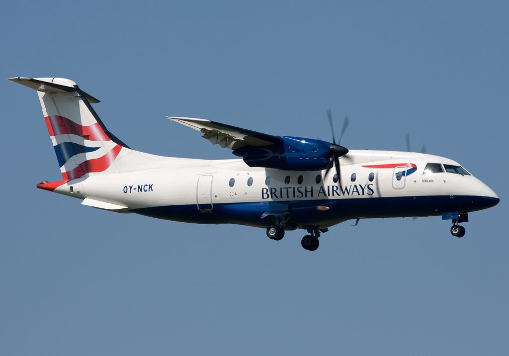 A Sun-Air Dornier 328 in British Airways livery flying in the sky.