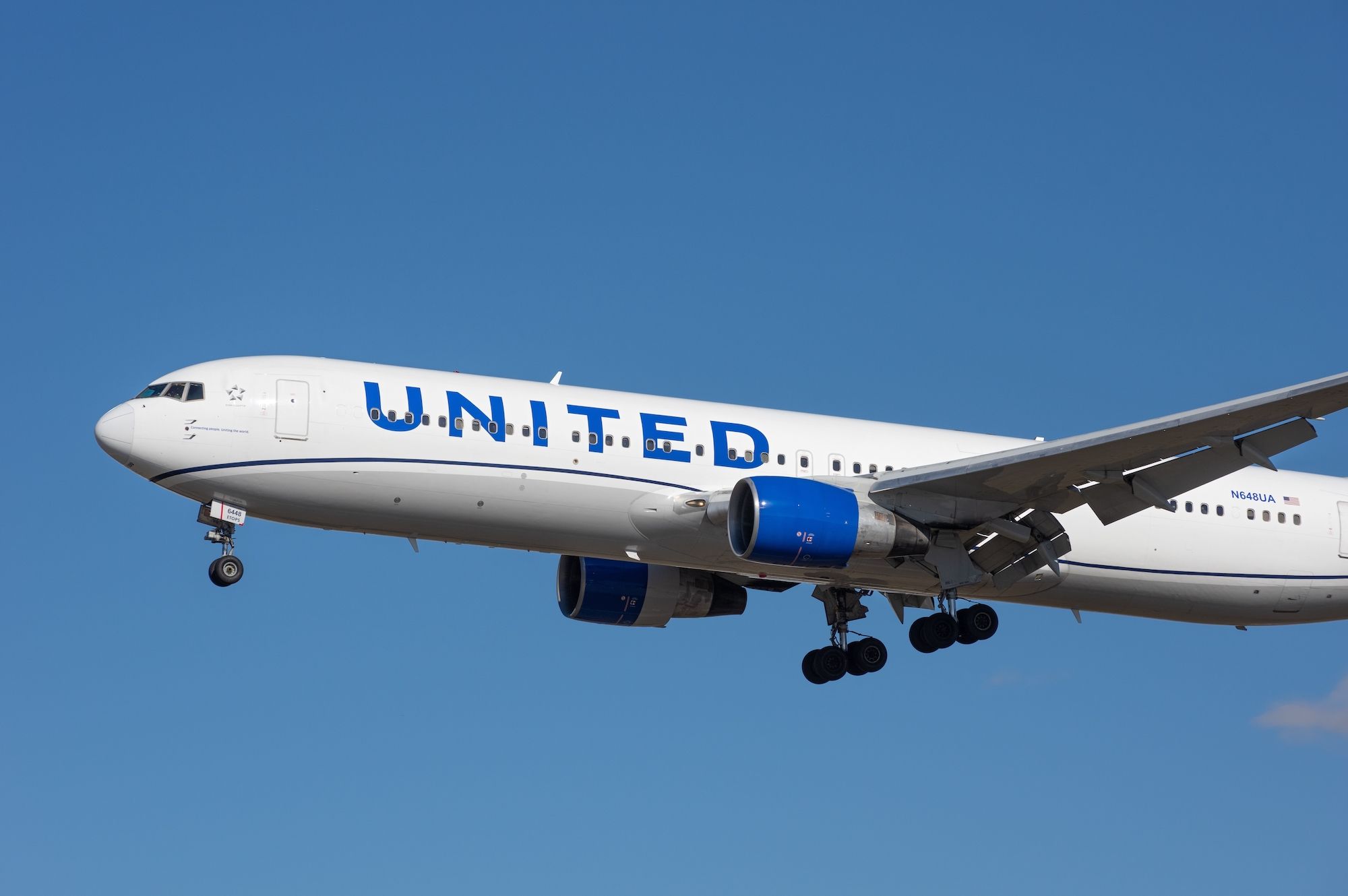 A United Airlines Boeing 767 soars in the sky.