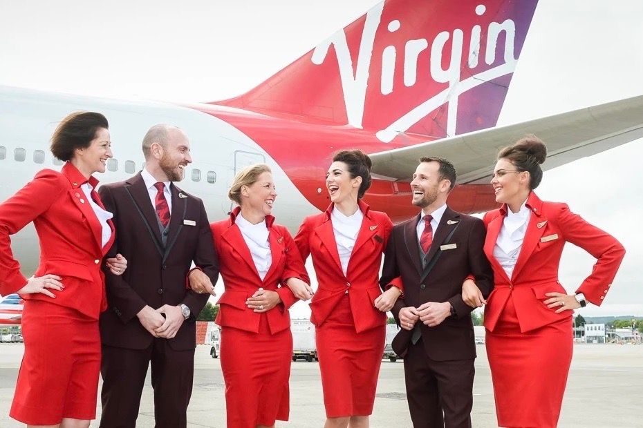 Several Virgin Atlantic cabin crew members standing in front of an aircraft.