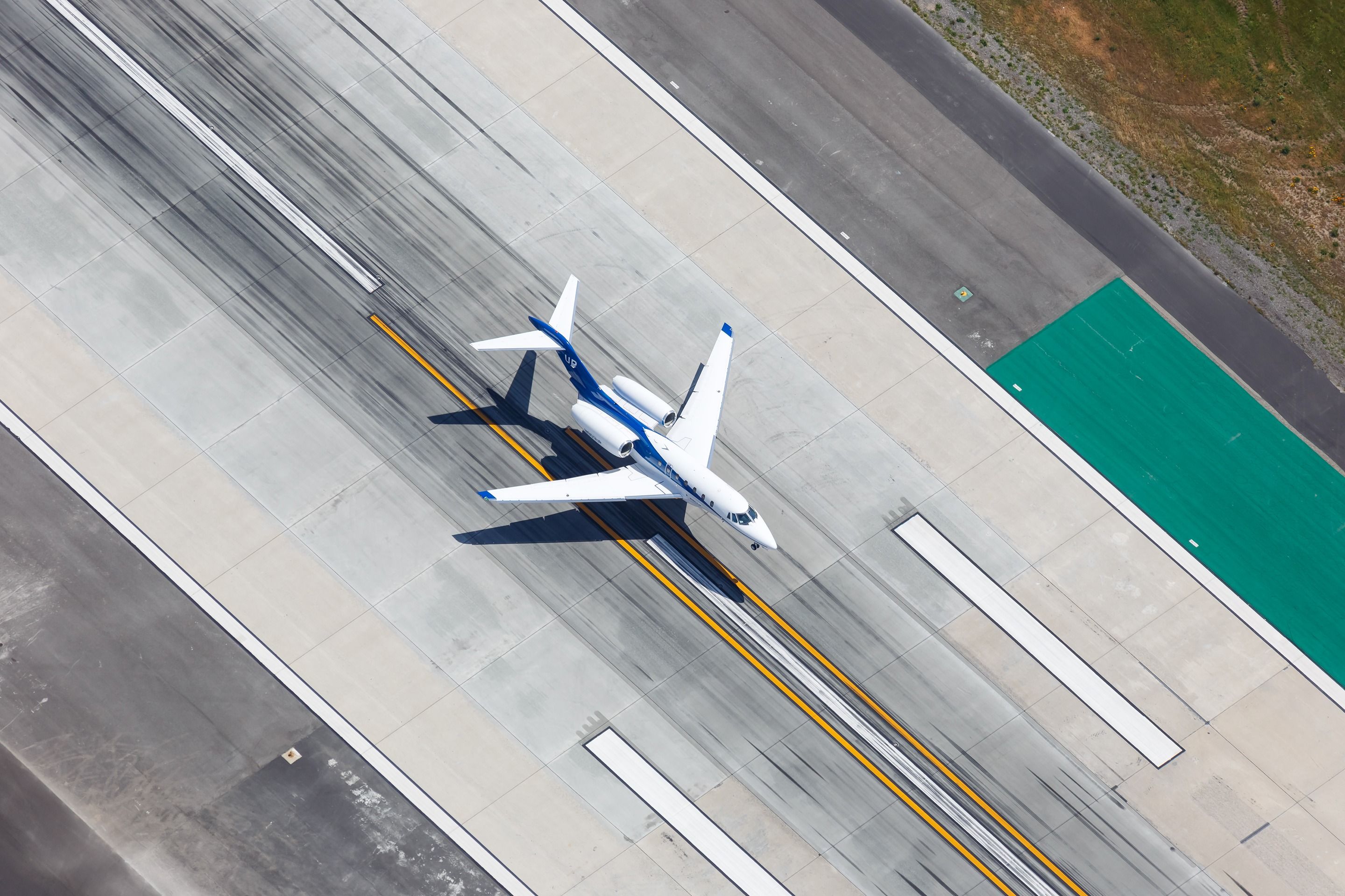 A Wheels Up Cessna Citation X about to land on a runway.