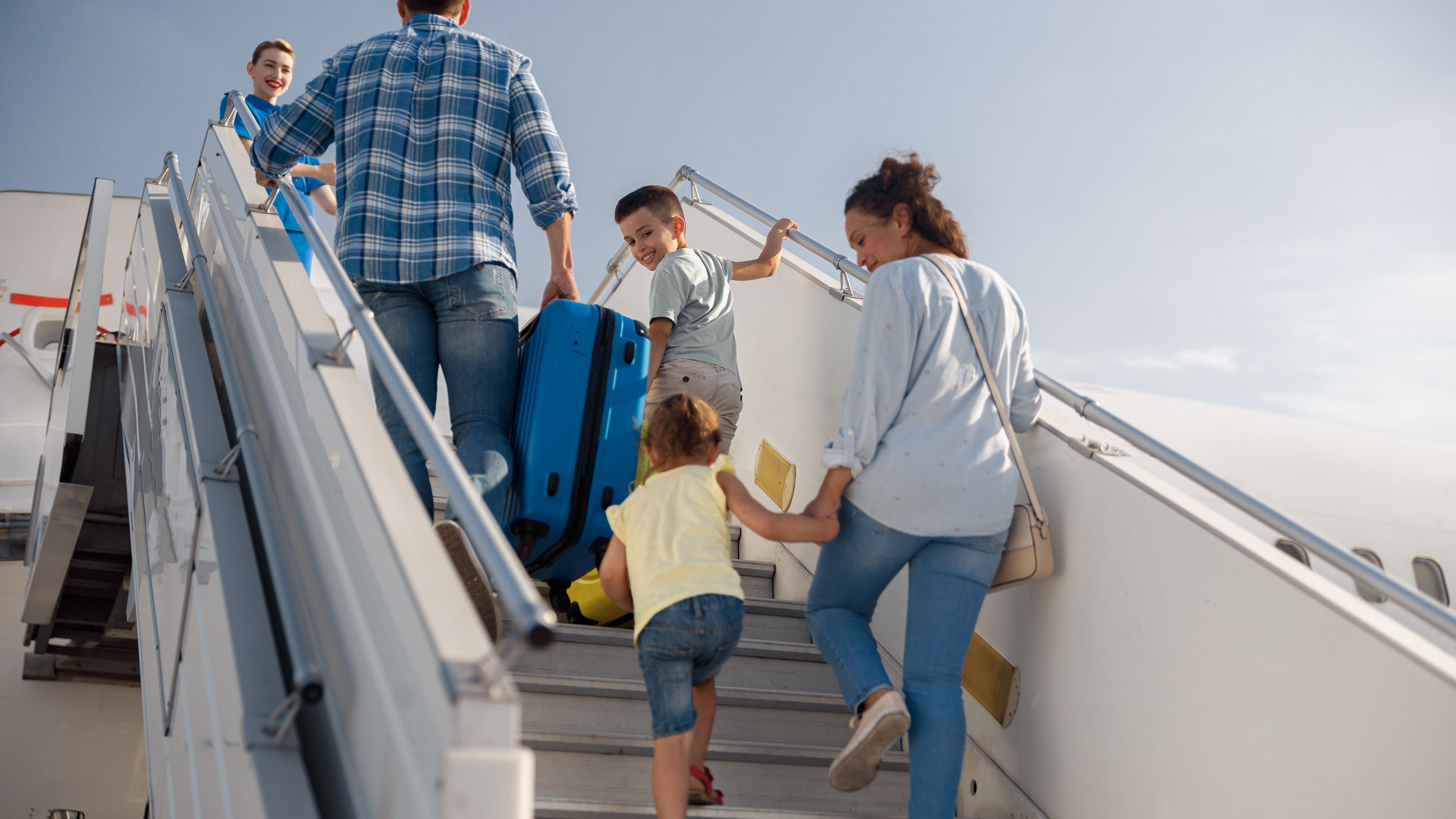 A Father, Mother, and Two Children boarding an aircraft.