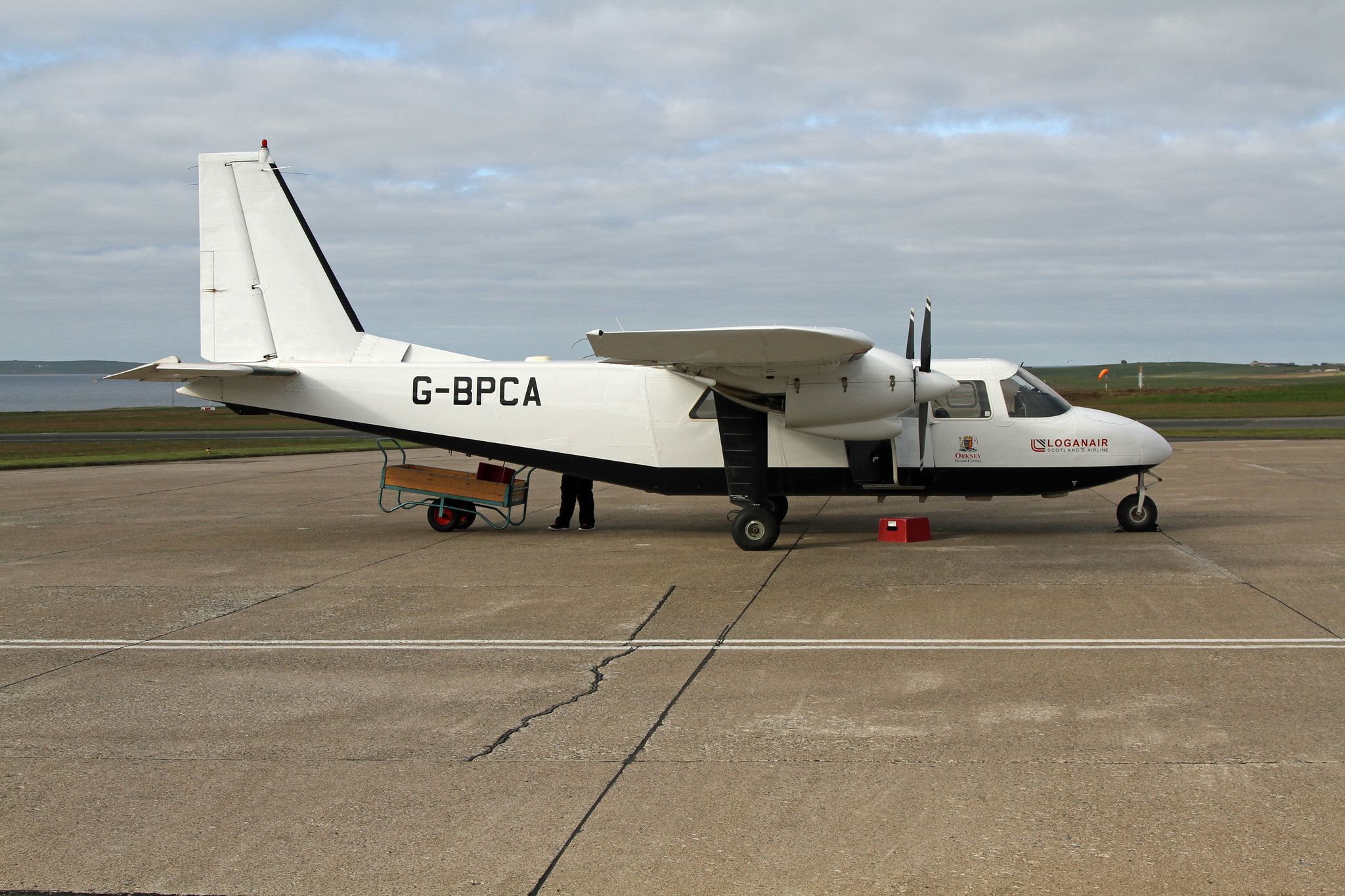 A Loganair Britten Norman Islander parked on the apron at Kirkwell Airport