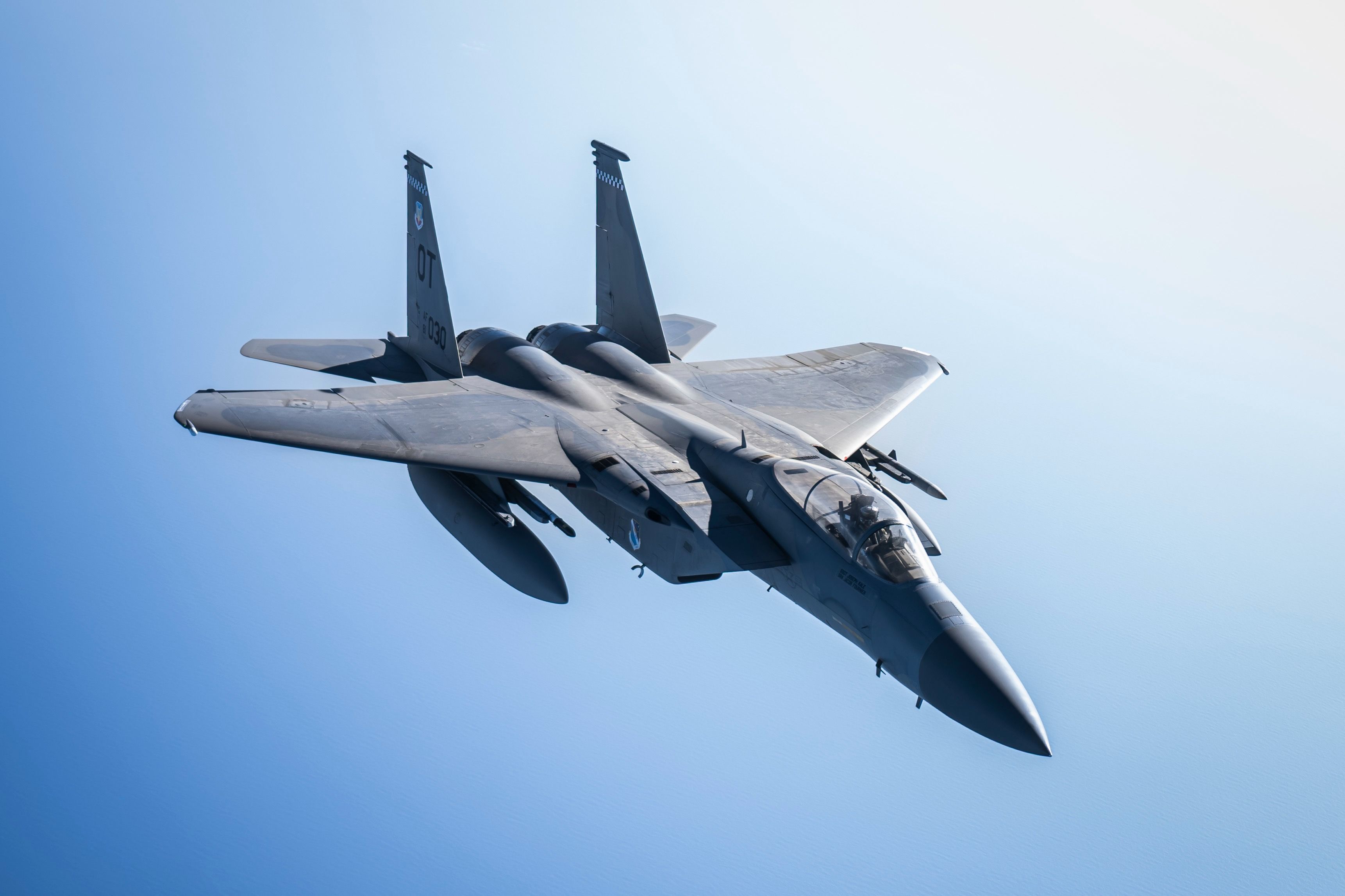 An F-15 Fighter jet flying in the sky.