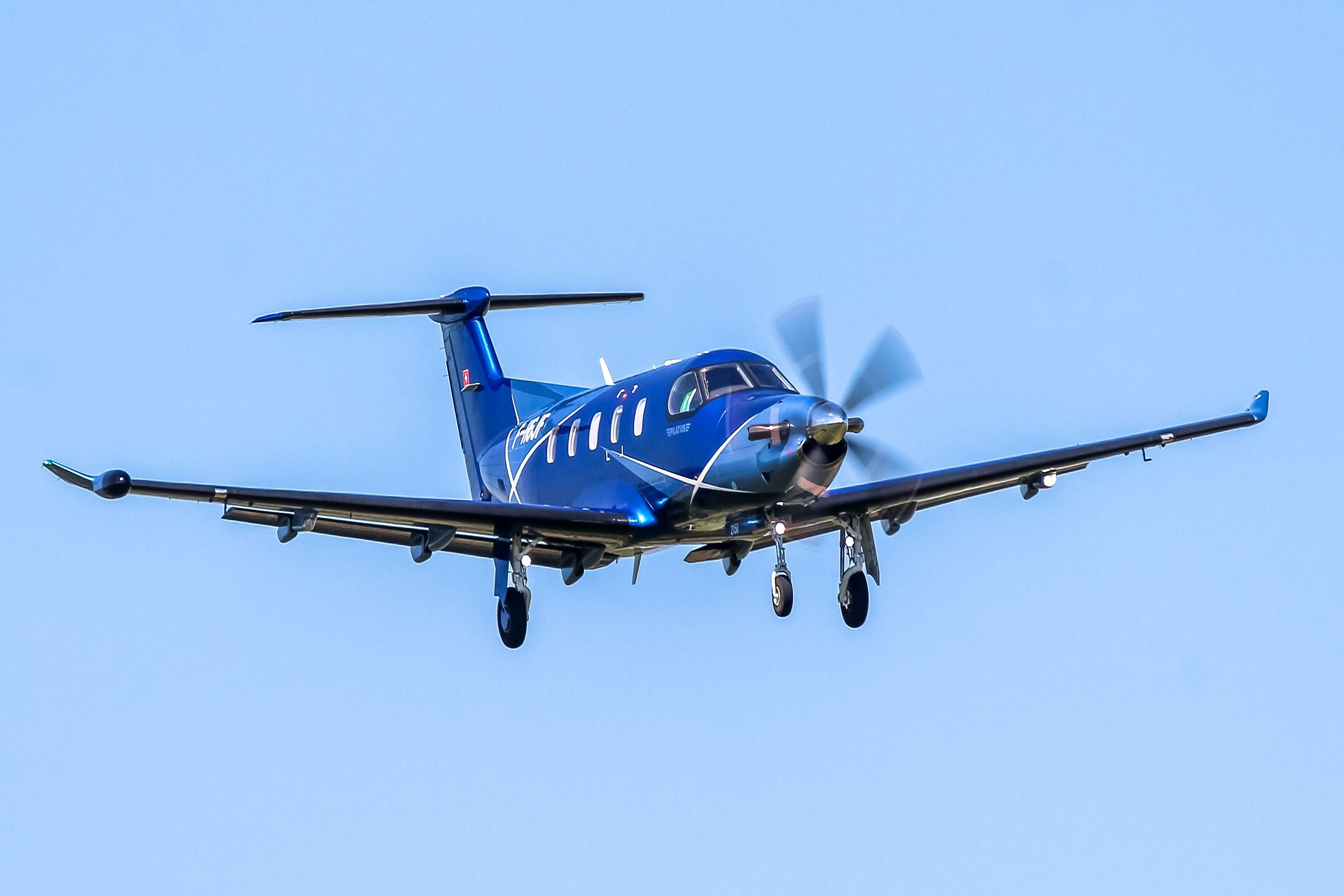 A Pilatus PC-12 flying in the sky.