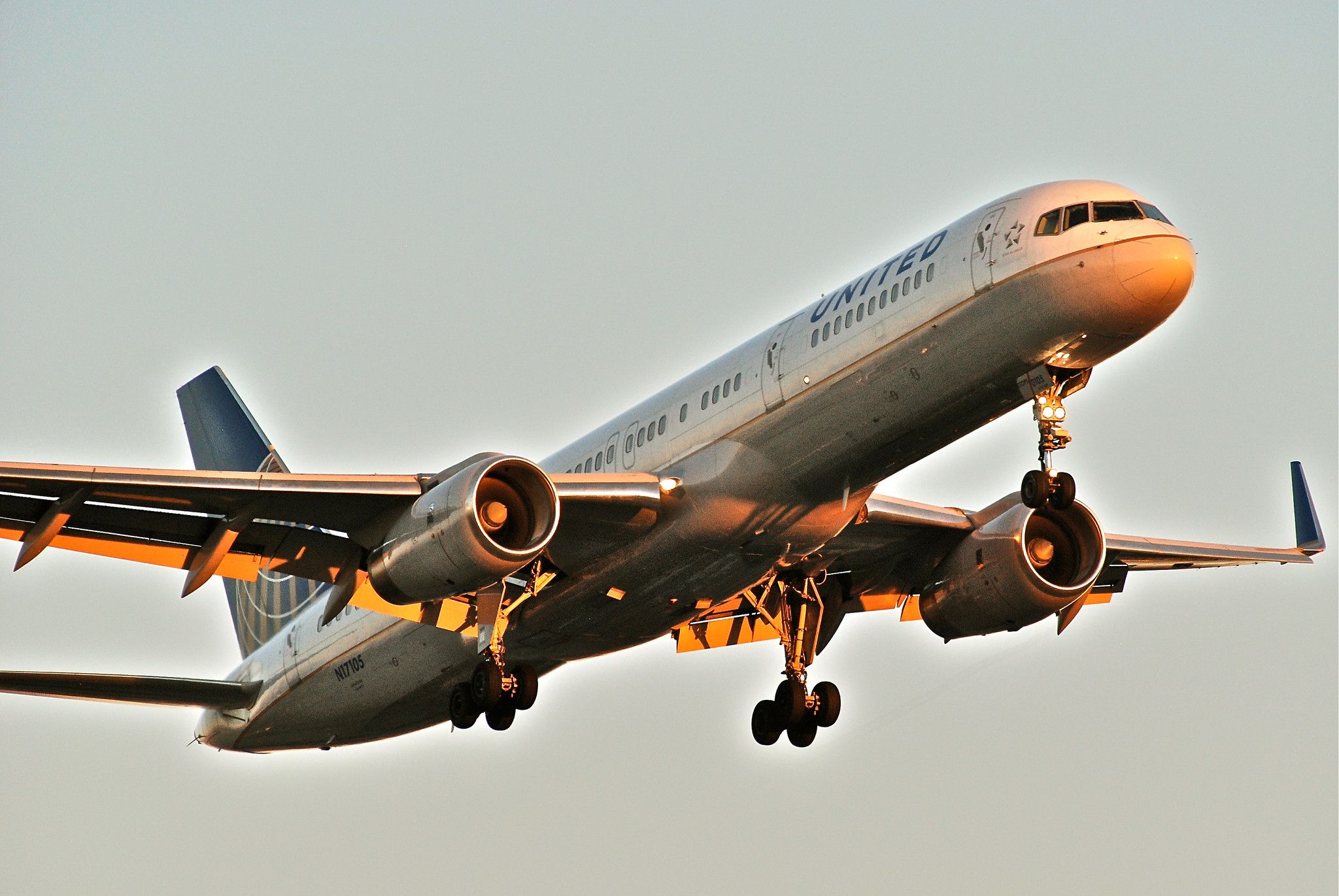 A United Airlines Boeing 757-200 flying in the sky.