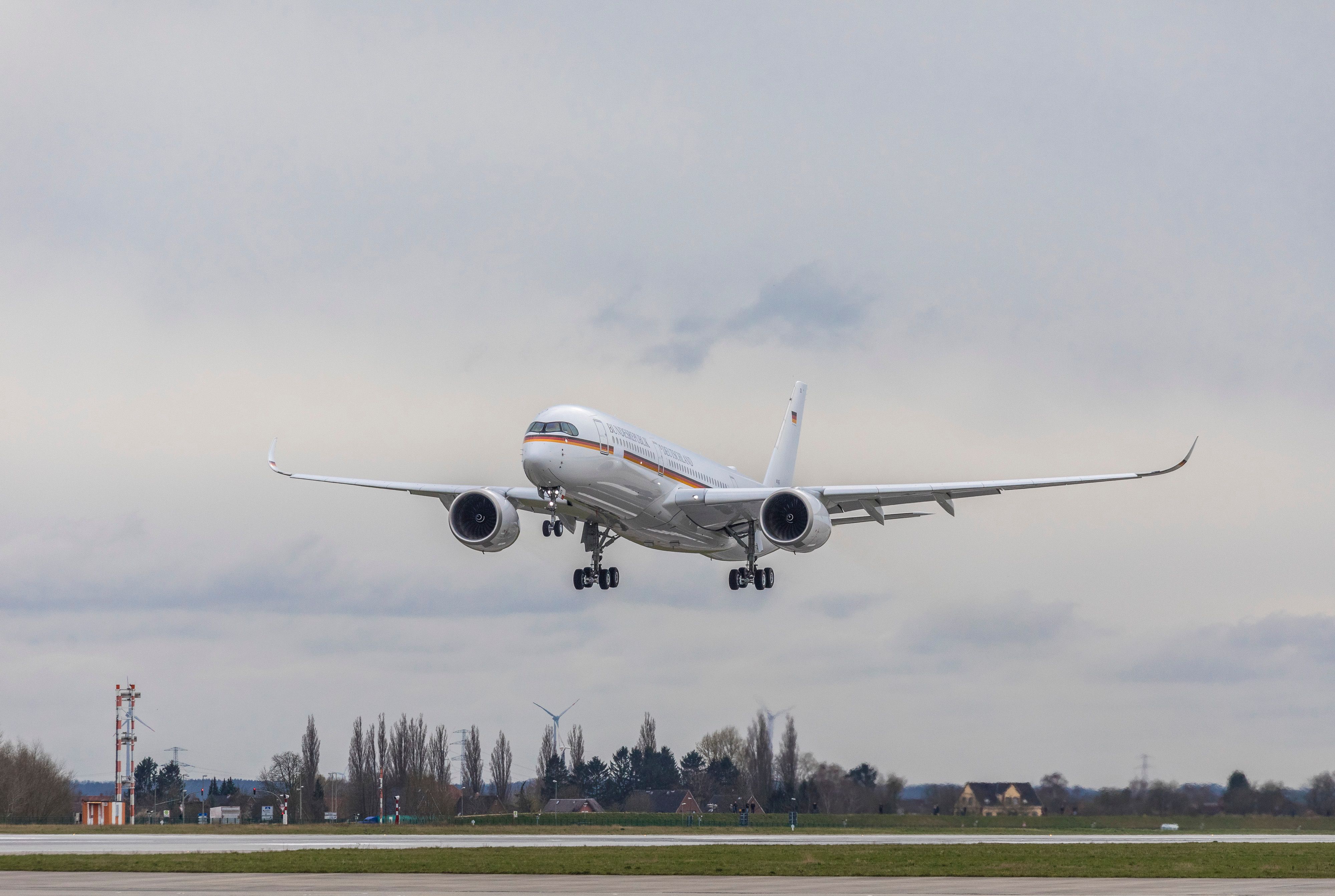 The German Air Force One , an Airbus ACJ350, about to land on a runway.