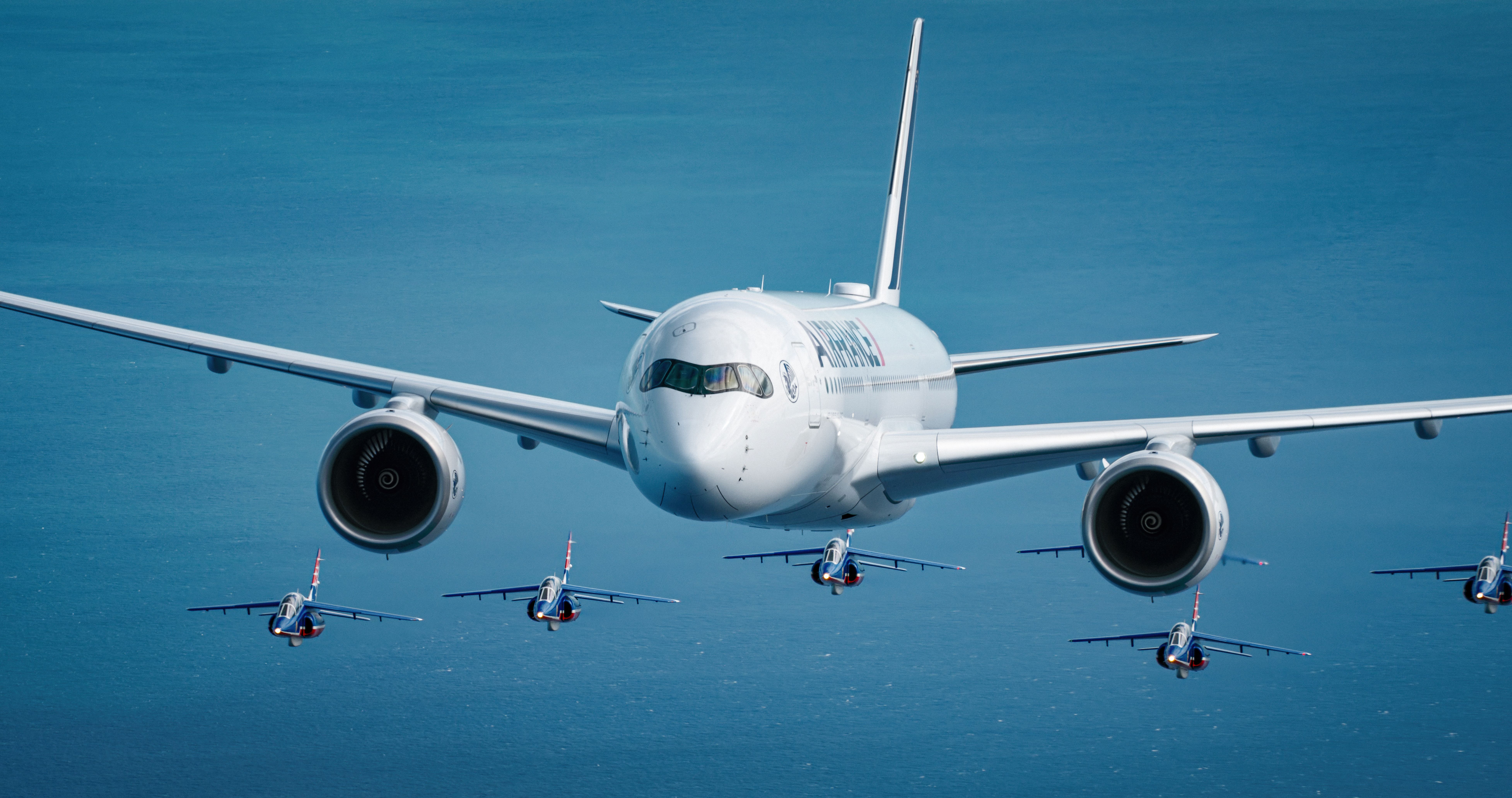 An Air France's Airbus A350 being followed by several fighter jets.