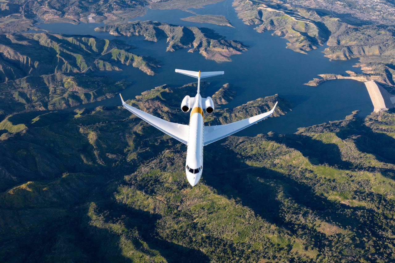 A Bombardier Global 7500 flying over mountains.