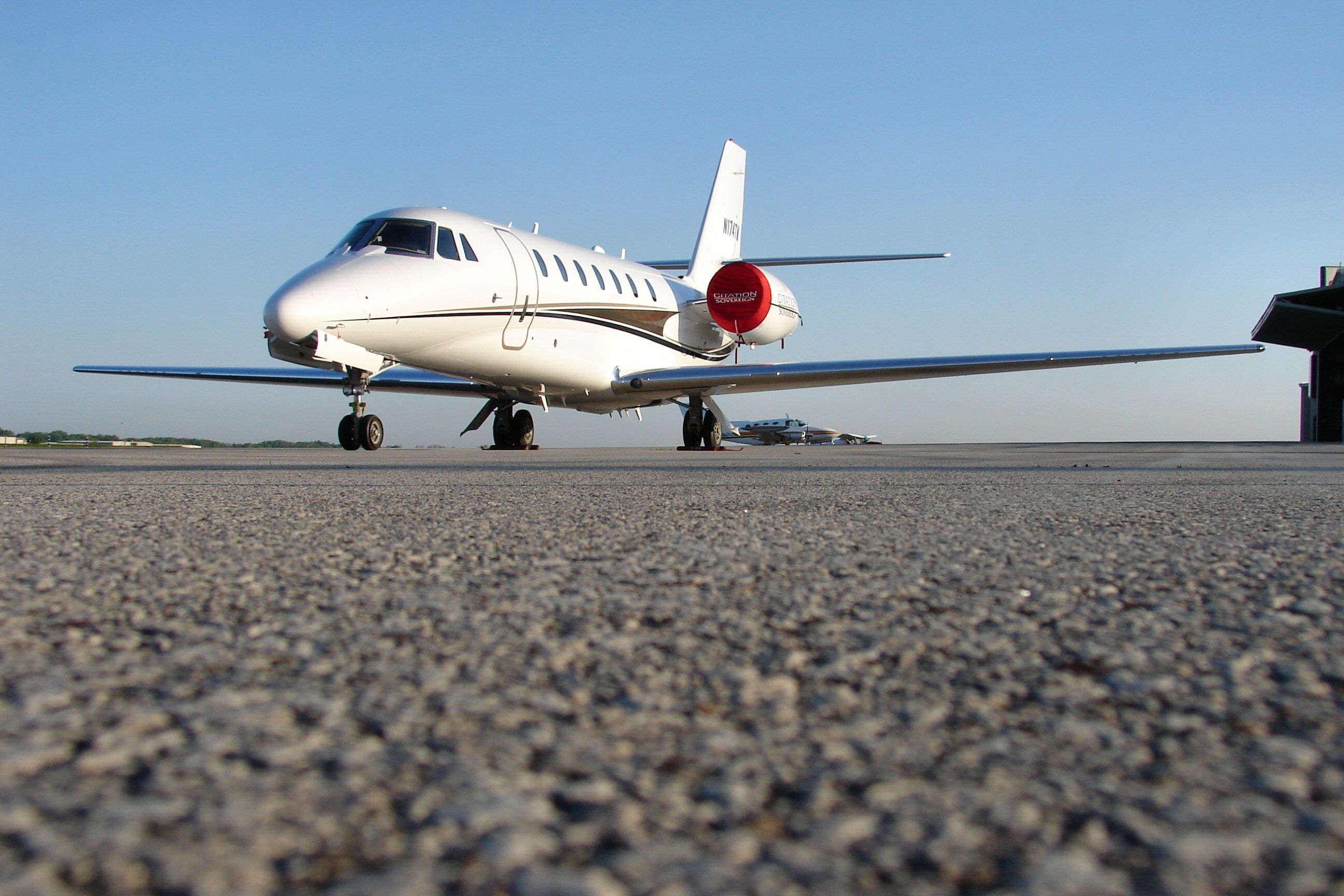 A Cessna Citation Soverign Parked On An Airport Apron.