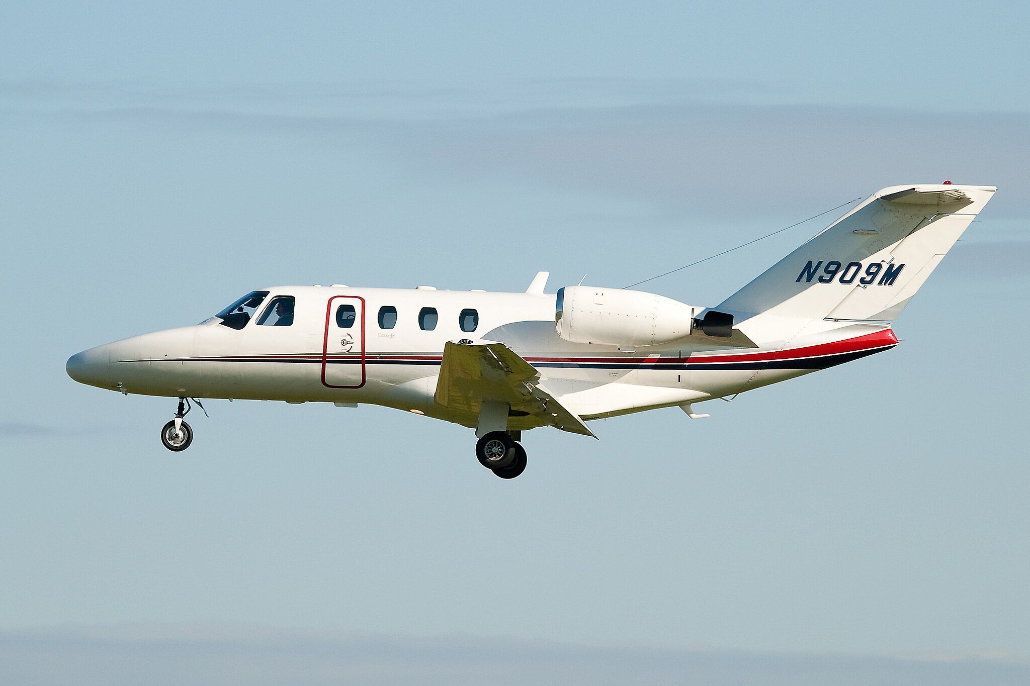 A Cessna CitationJet CJ1 flying in the sky.