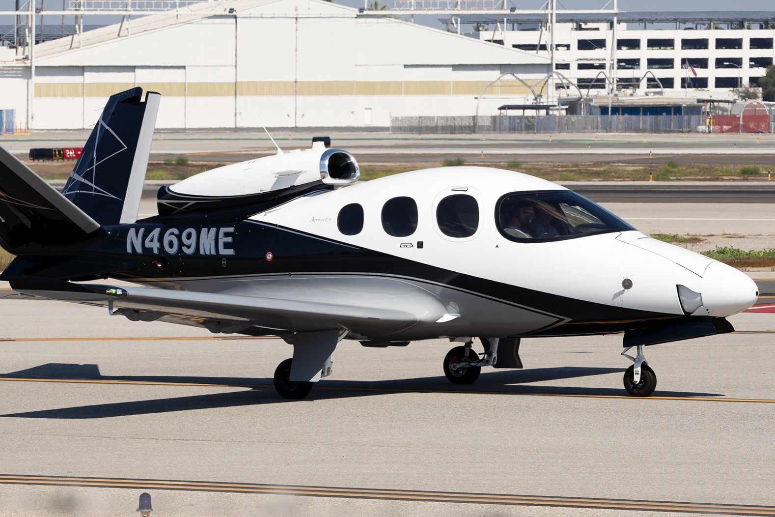A Cirrus Vision Jet SF50 on an airport apron.