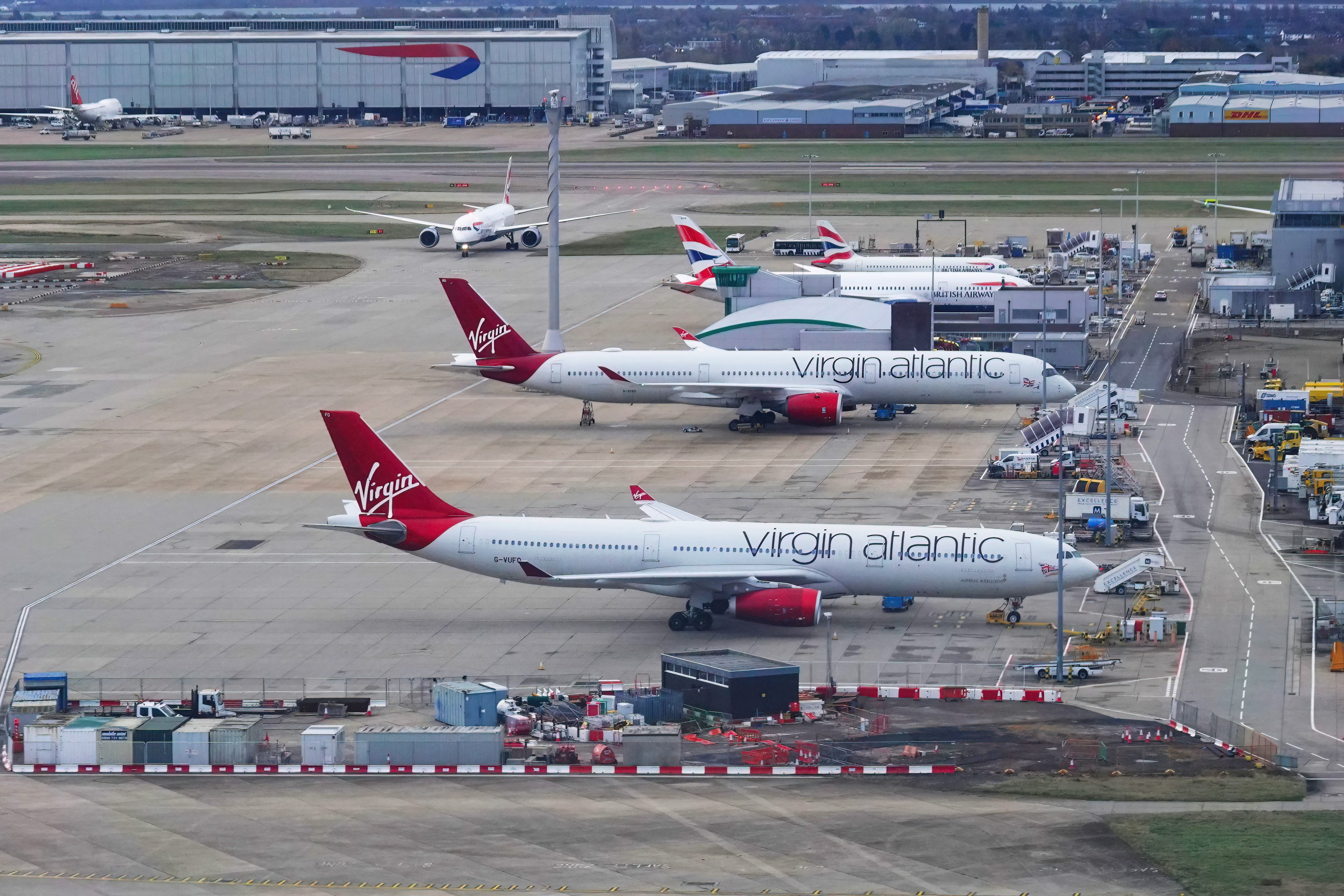 Two Virgin Atlantic and British Airways aircraft on the apron at London Heathrow airport.