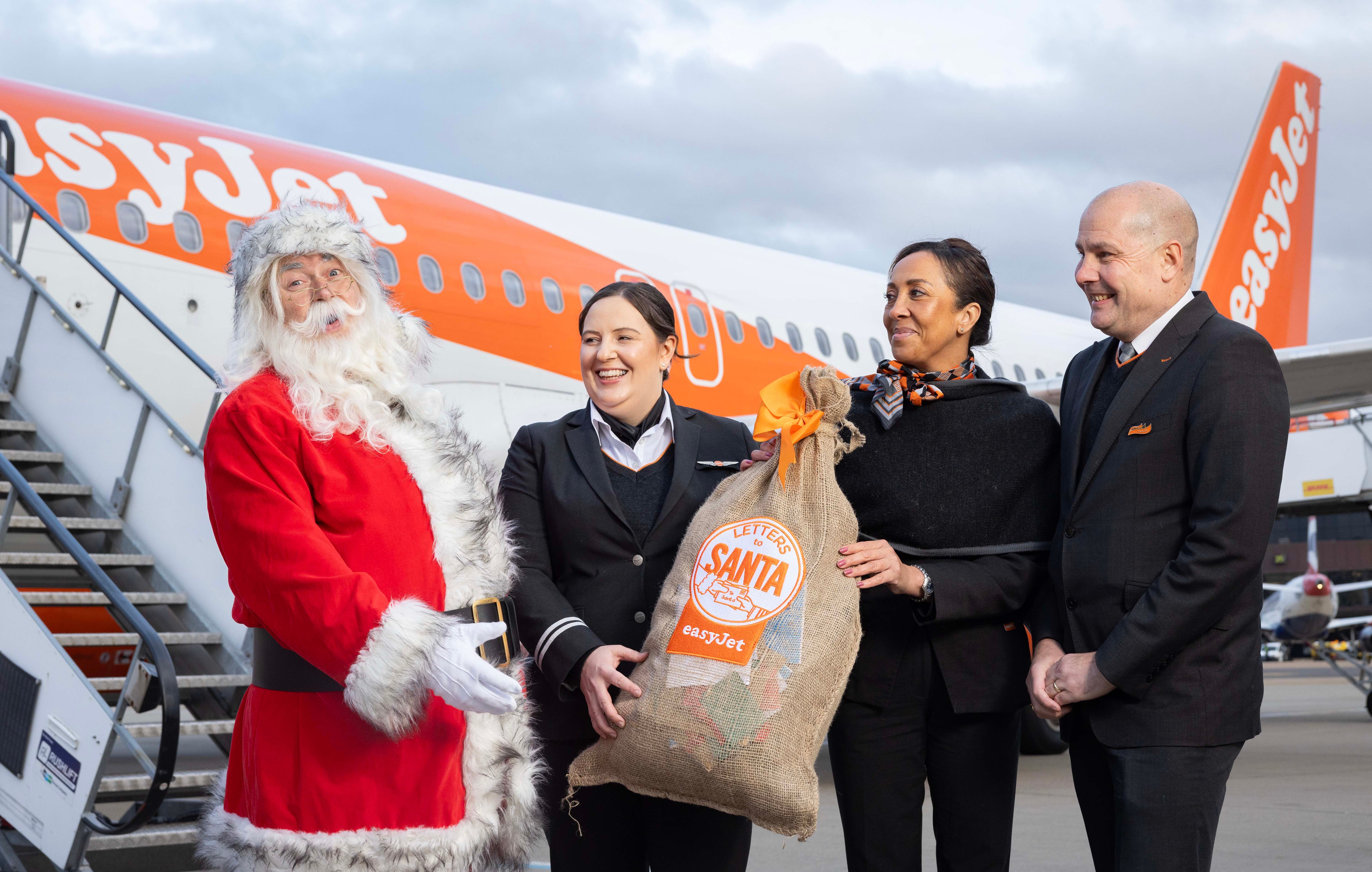 easyJet Cabin Crew With Father Christmas By A Plane