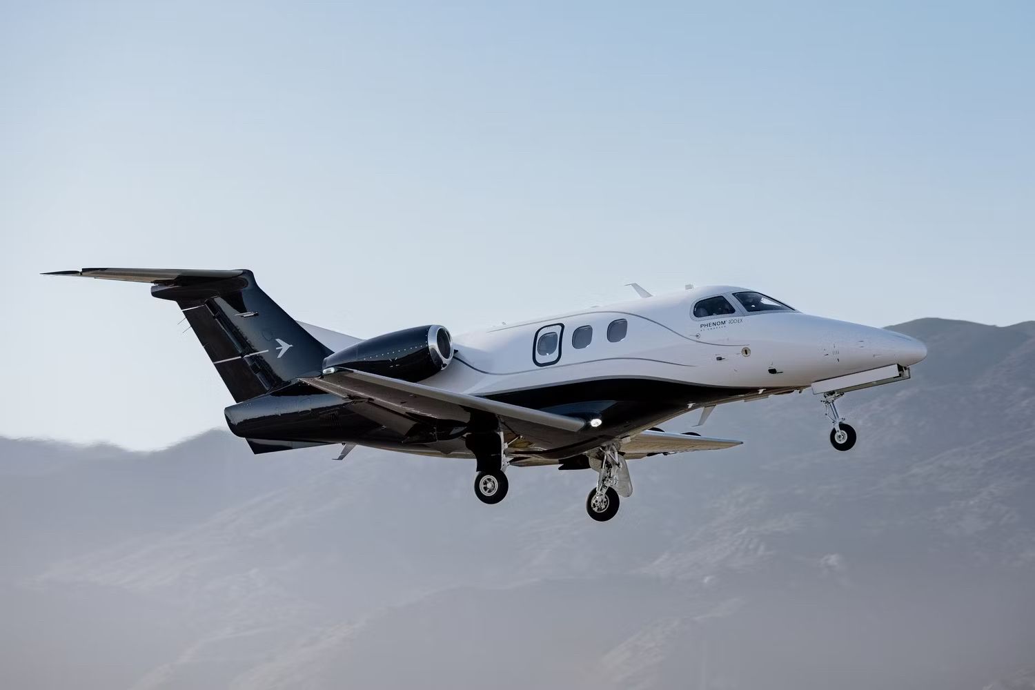 An Embraer Phenom 100EX Flying in the sky.